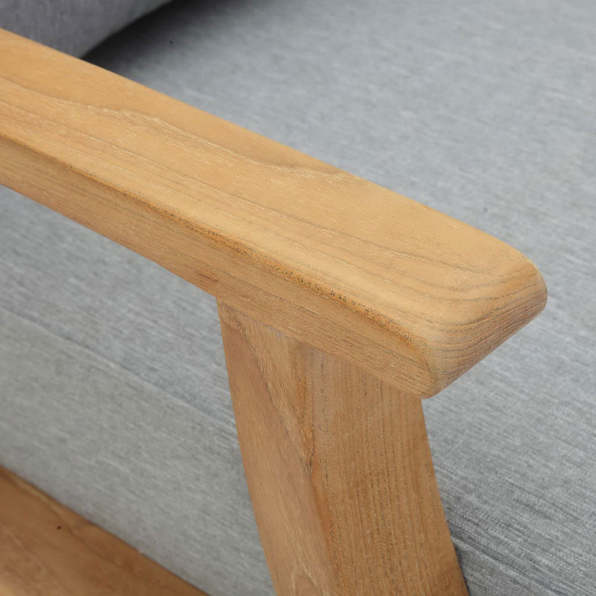 Smoothly finished teak armrest detail resting above the tailored gray cushion || EEI-1143-NAT-GRY-SET || detail_studio