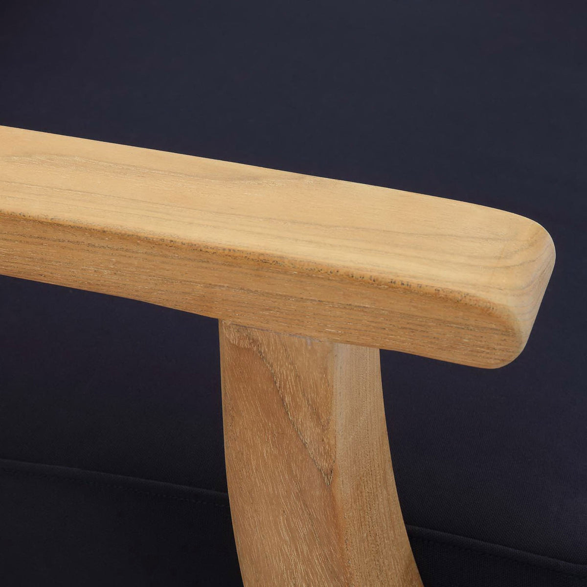 Smooth rounded teak armrest detail set against dark navy cushion fabric || EEI-1143-NAT-NAV-SET || detail_studio
