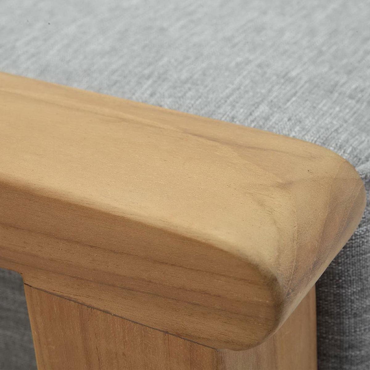 Rounded teak armrest with softly smoothed edges beside the tailored gray cushion. || EEI-1152-NAT-GRY-SET || detail_studio