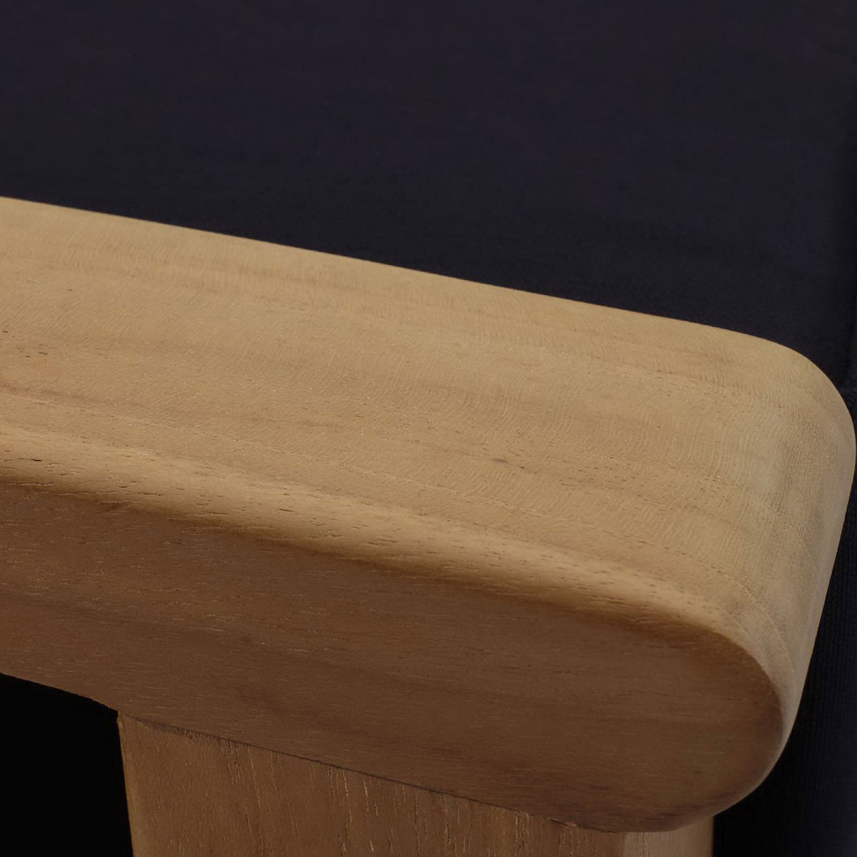 Rounded teak armrest with soft edges paired with a tailored navy cushion. || EEI-1152-NAT-NAV-SET || detail_studio
