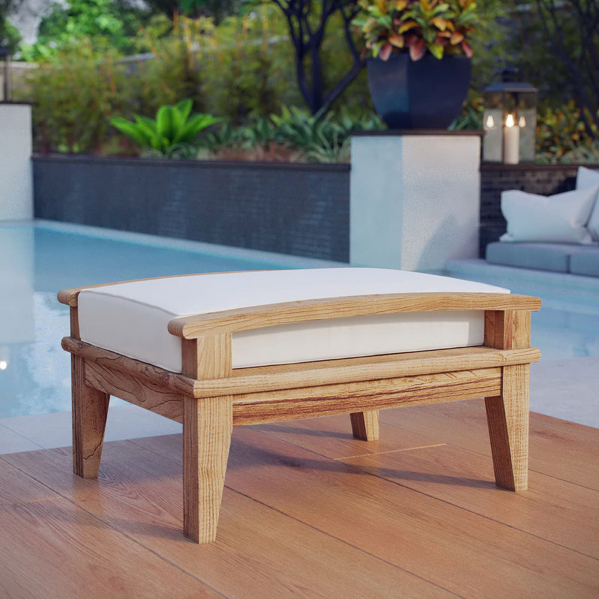 Teak ottoman with white cushion styled beside a poolside deck for resort-inspired relaxation. || EEI-1152-NAT-WHI-SET || front_angle_room