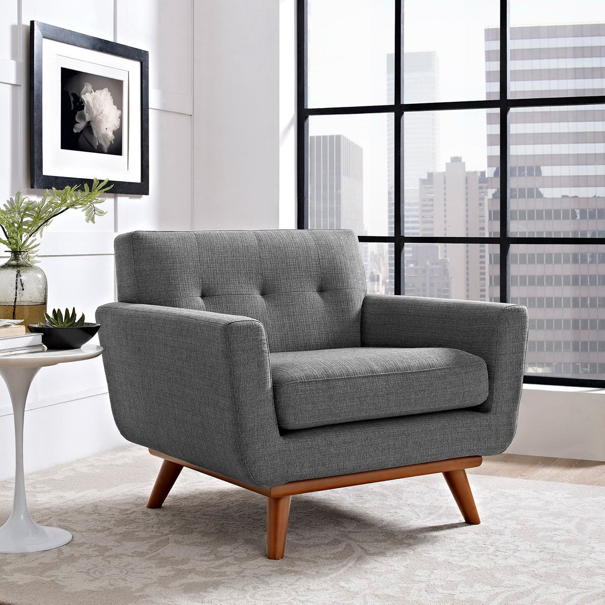 Textured dark gray fabric and splayed wood legs bring midcentury character to the living room.