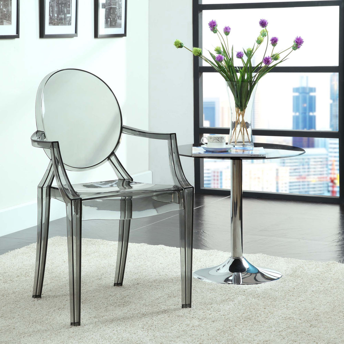 Smoky gray transparent armchair lends modern polish beside a gleaming pedestal table