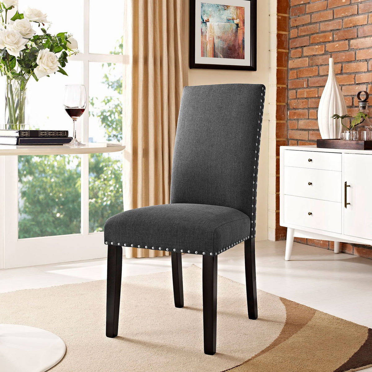 Gray nailhead dining chair styled in a bright contemporary dining room || EEI-1384-GRY || front_angle_room