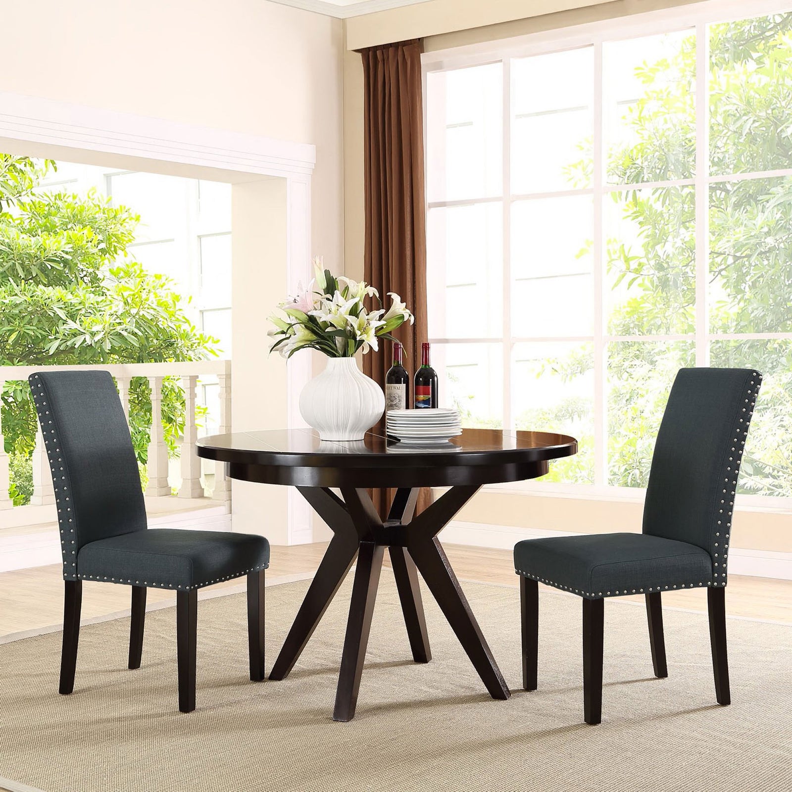 Pair of gray nailhead dining chairs around round espresso dining table in airy room || EEI-1384-GRY || front_angle_room