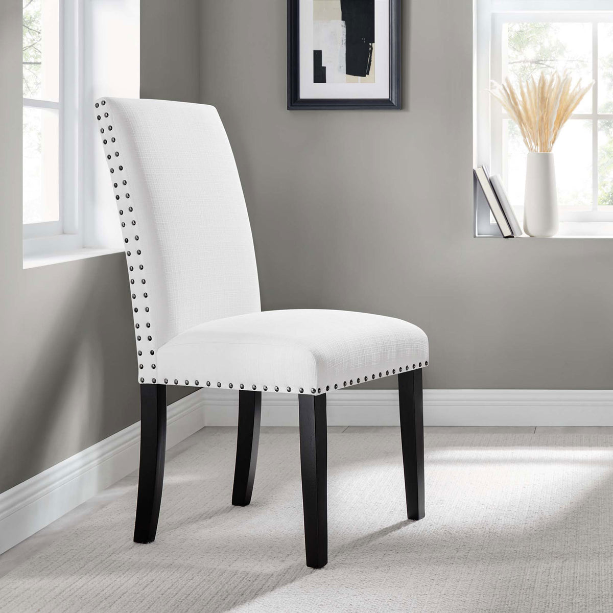 White upholstered dining chair in a modern neutral room with soft carpet flooring || EEI-1384-WHI || front_angle_room