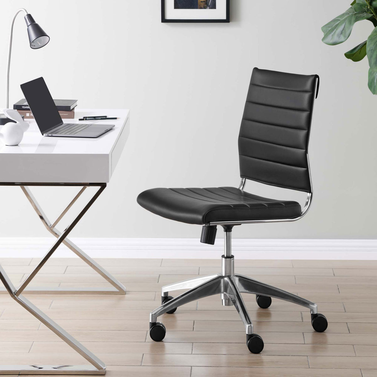 Jive armless office chair in a modern workspace, pairing black ribbed upholstery with a chrome swivel base || EEI-1525-BLK || front_angle_room