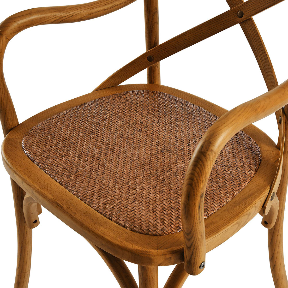 Textured rattan weave nestles inside a smooth walnut-tone seat frame with curved wood arms