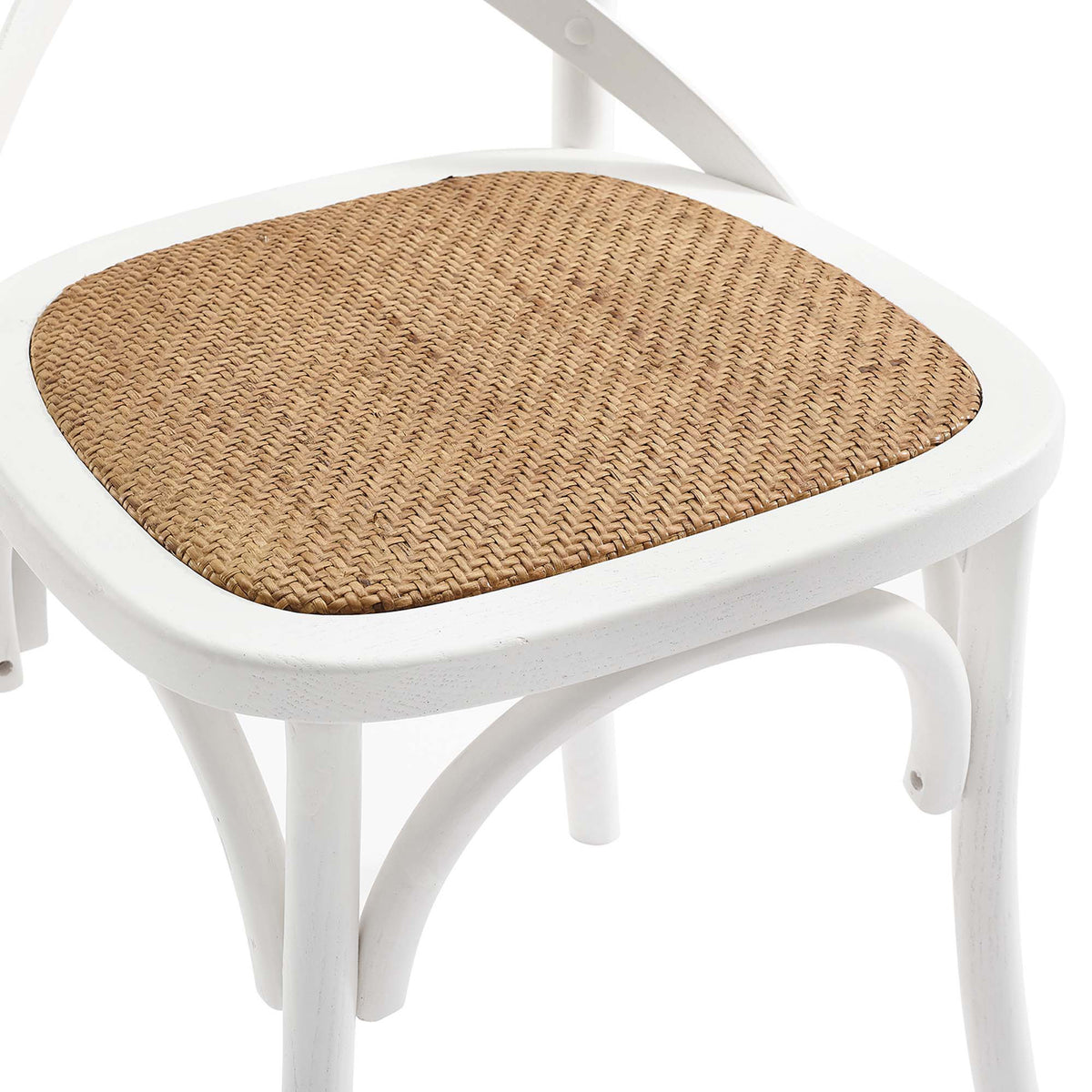 Natural rattan weaving adds warm texture to the smooth white wood seat frame