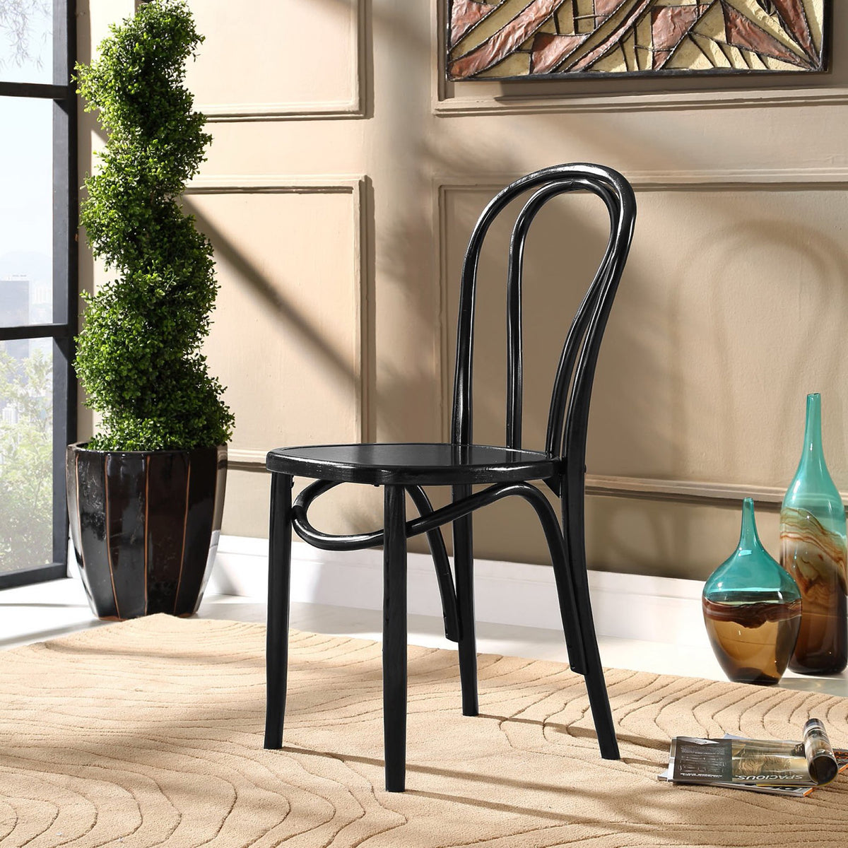 Black wood dining chair with an airy open back and arched supports for timeless appeal