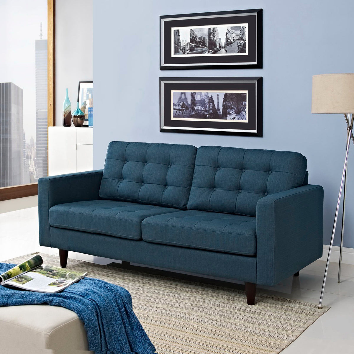 Azure blue loveseat pairs button-tufted cushions with generous seating and broad square arms.