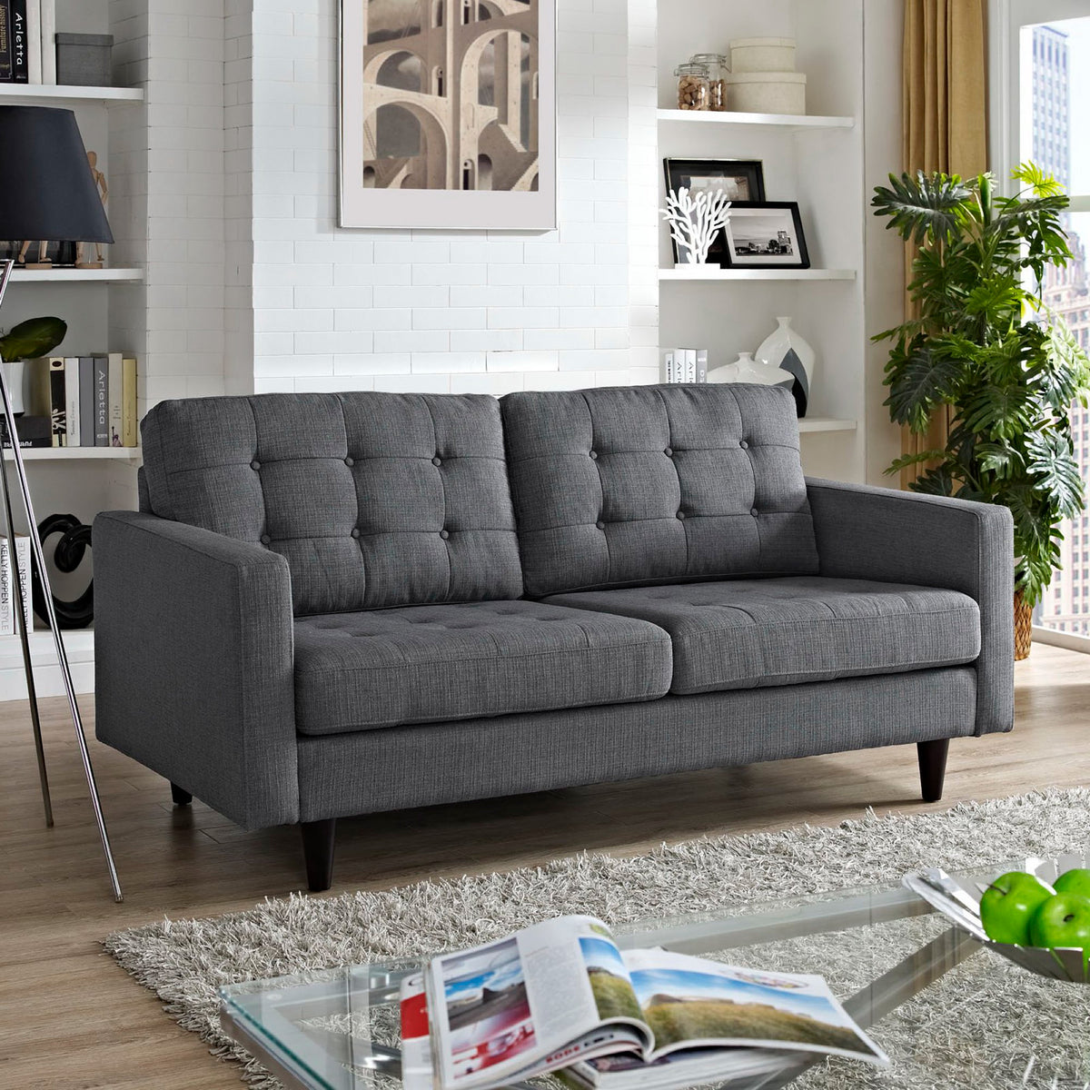 Gray loveseat offers button-tufted cushions, square arms, and dark tapered legs.