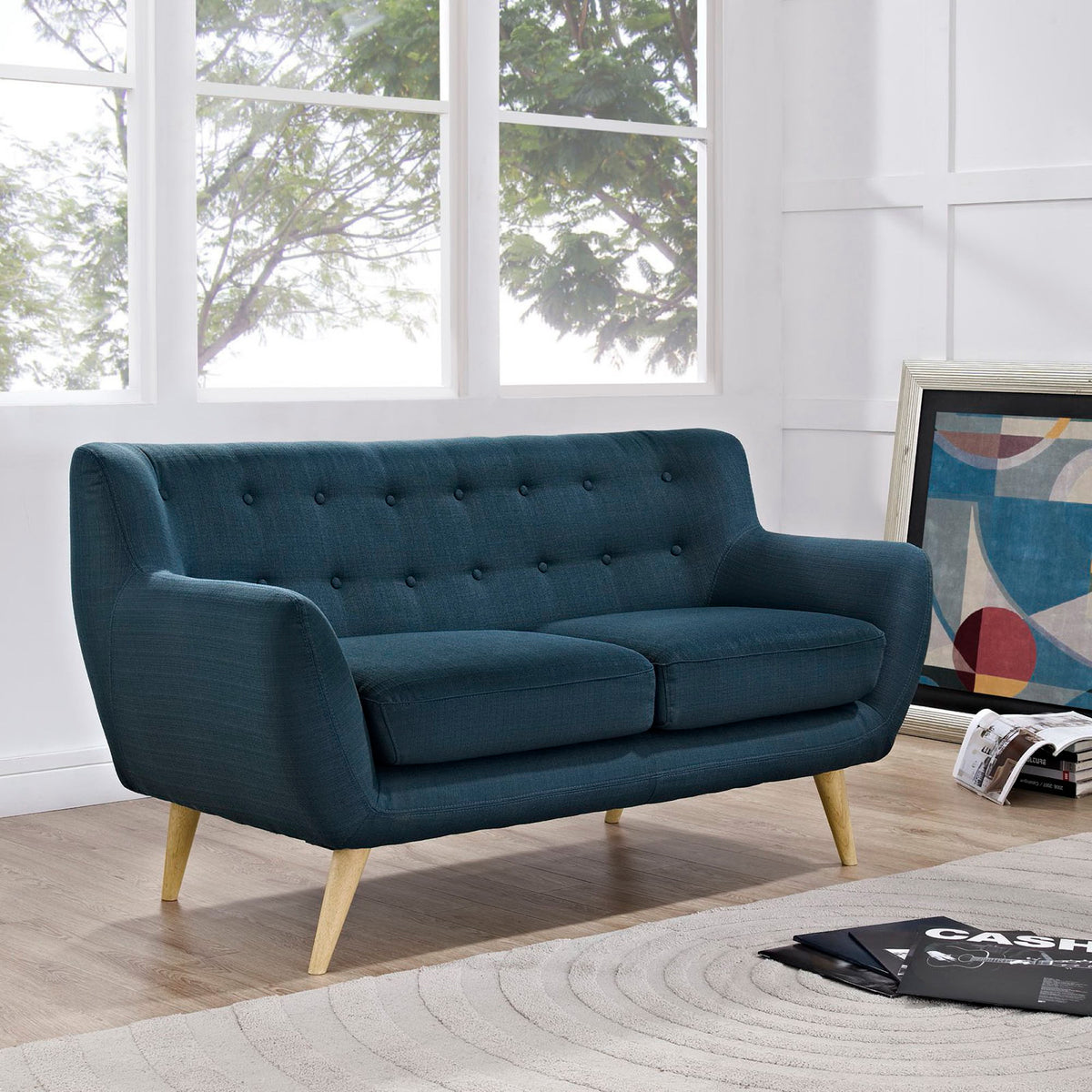 Azure blue loveseat with tufted upholstery, rounded arms, and inviting two-cushion seating