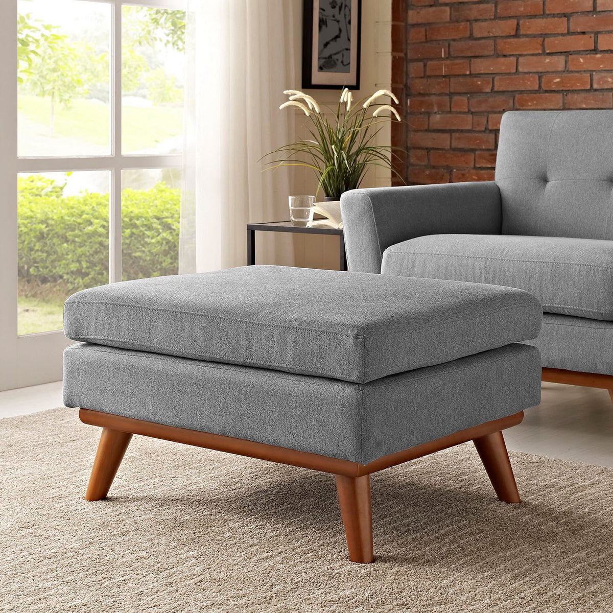 Soft gray ottoman offers a comfortable place to put your feet beside a matching chair