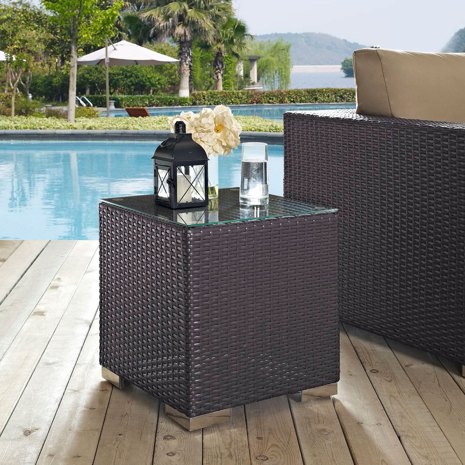 Poolside espresso rattan side table with glass top styled with lantern and drink || EEI-1909-EXP || front_angle_room