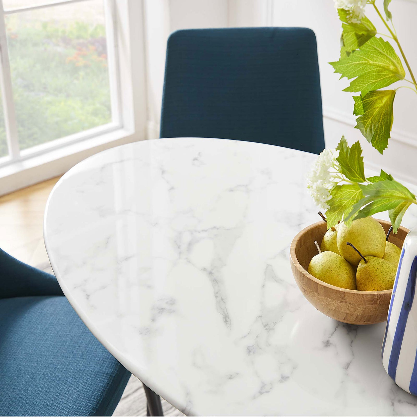 Glossy faux marble tabletop pairs with modern blue chairs to create an inviting compact dining spot || EEI-2021-WHI || detail_room