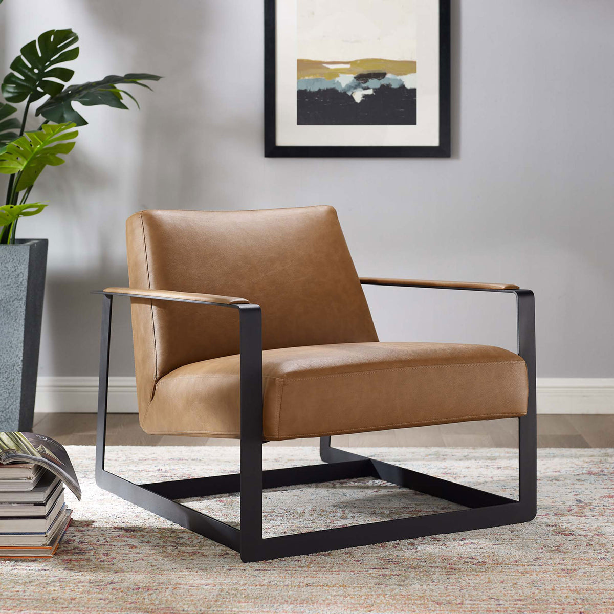 Sculptural lounge chair warms the room with tan vegan leather atop a bold matte black stainless steel frame || EEI-2075-TAN || front_angle_room