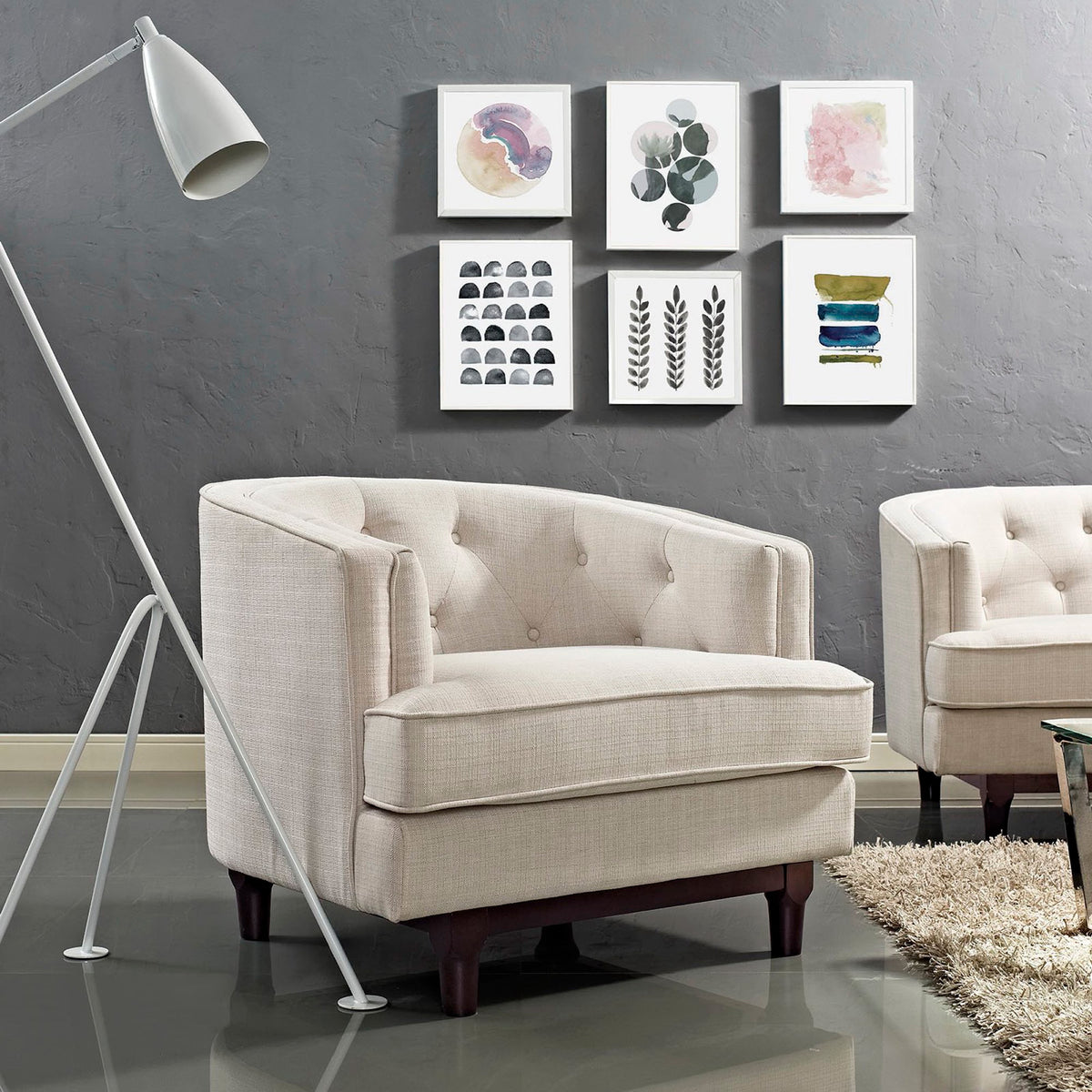 Button-tufted beige armchair with a plush seat and dark wood legs adds comfort to a living space