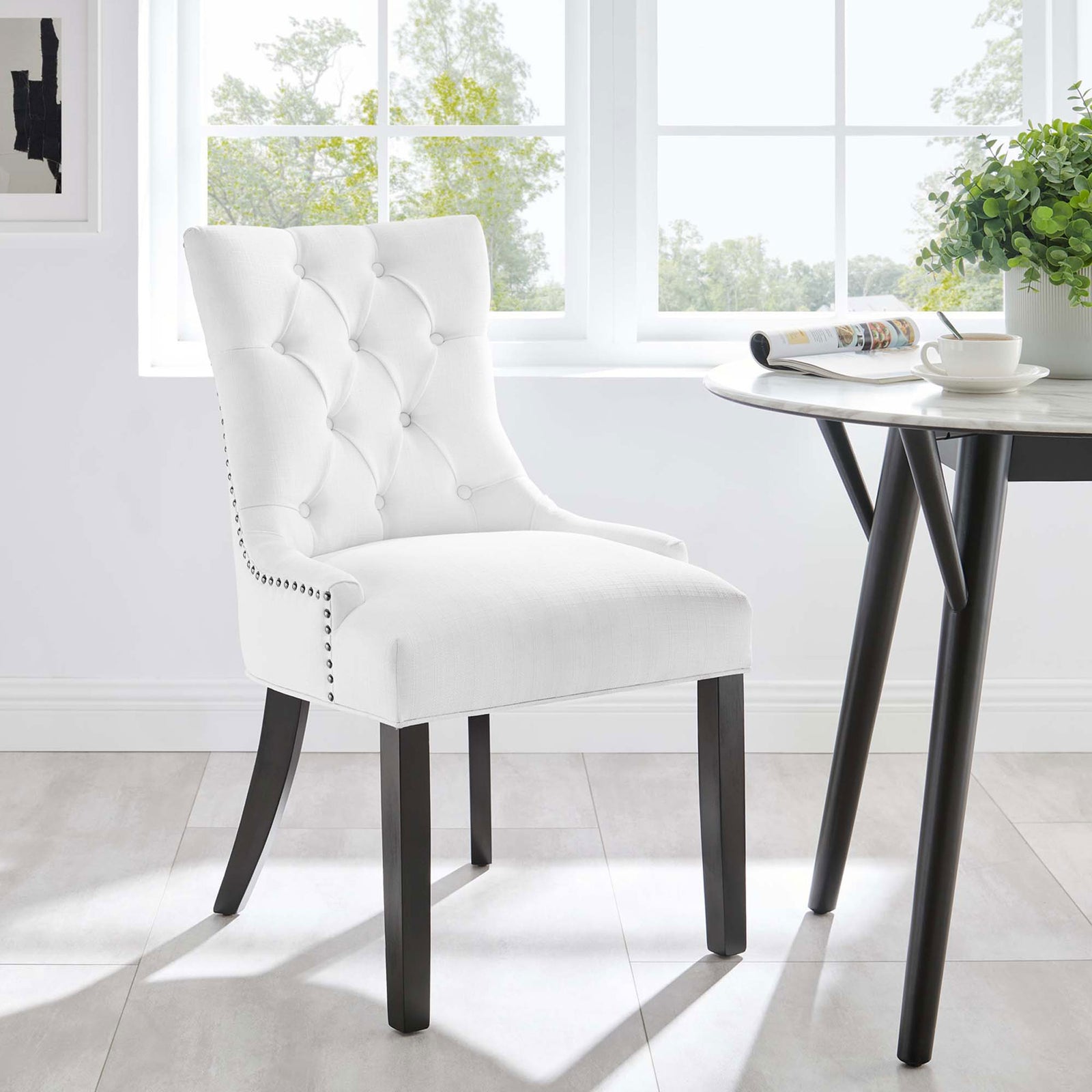 White tufted dining chair styled beside a modern round table in a sunlit breakfast nook || EEI-2223-WHI || front_angle_room