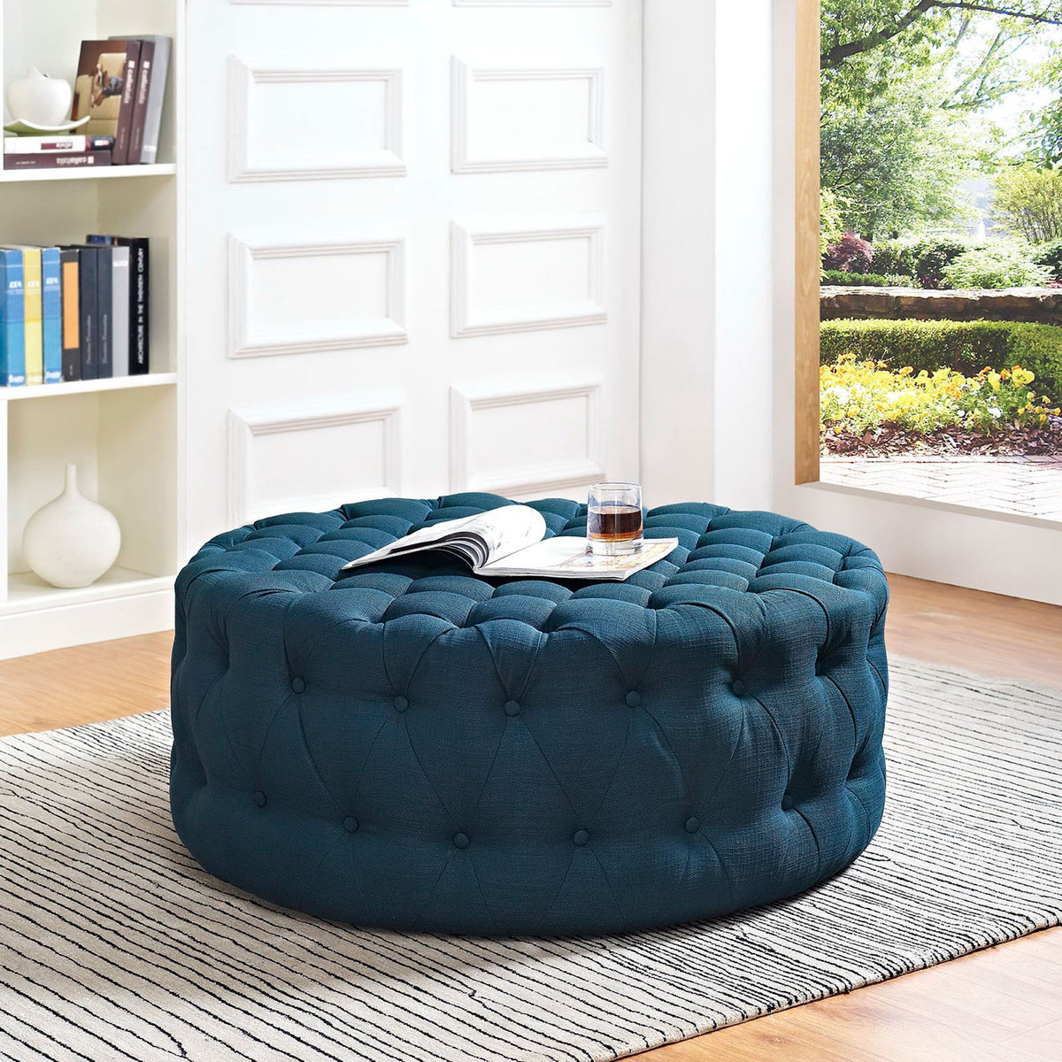 Azure tufted ottoman styled in a bright living room, perfect as a coffee table or extra seating || EEI-2225-AZU || front_angle_room