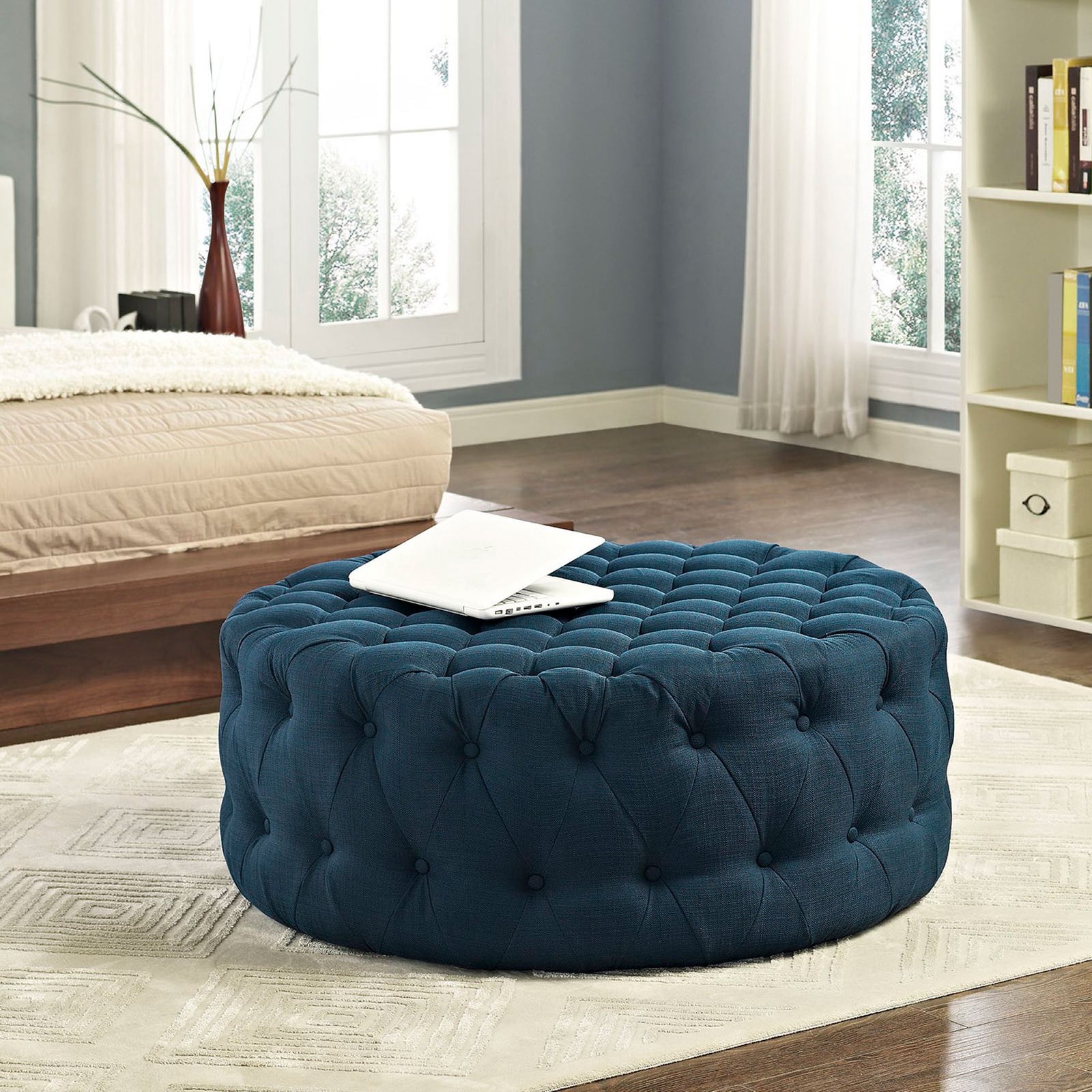 Tufted azure ottoman at the foot of a bed, adding cozy texture and a convenient spot to rest a tray || EEI-2225-AZU || front_angle_room