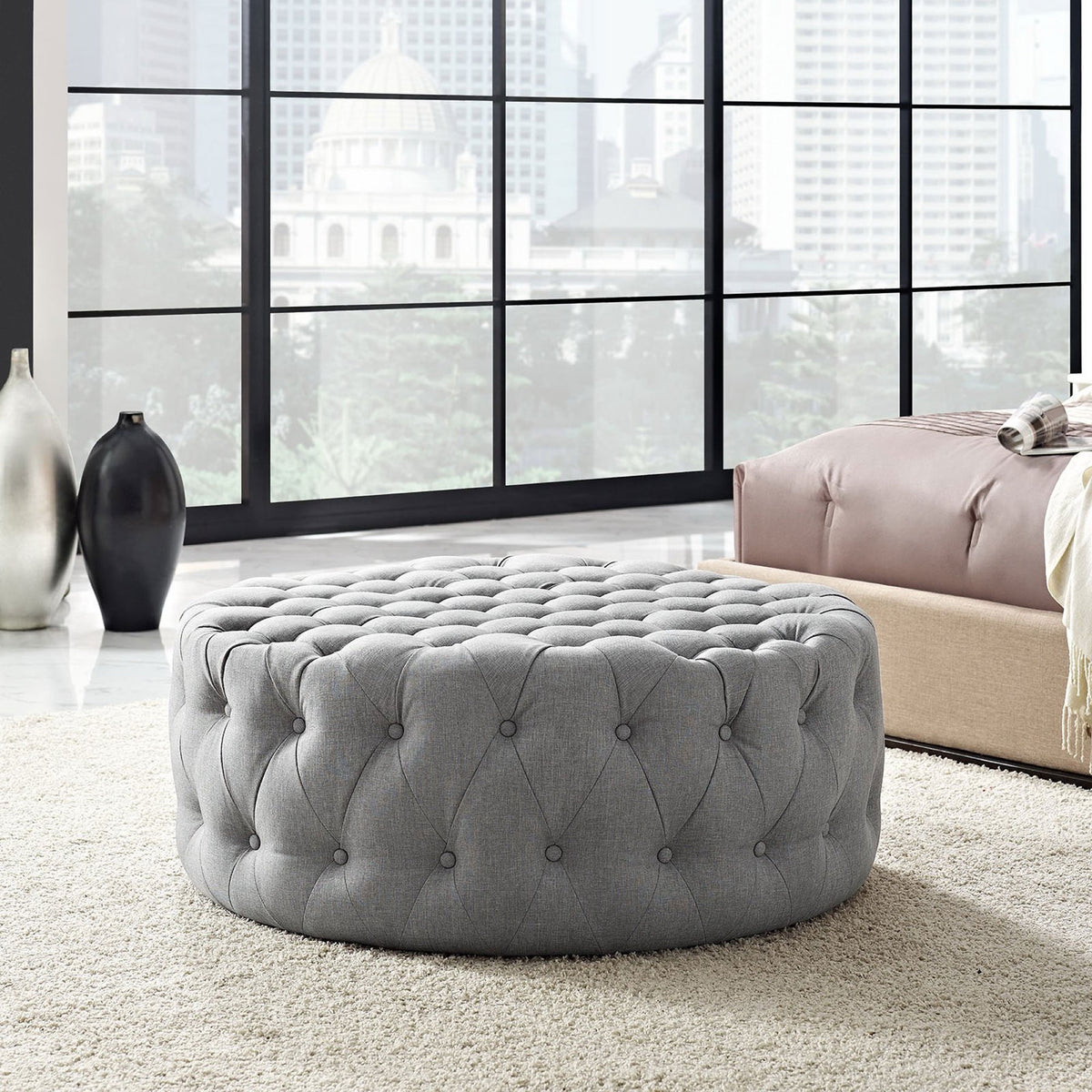 Light gray tufted ottoman adds plush texture as a modern accent in the bedroom || EEI-2225-LGR || front_angle_room