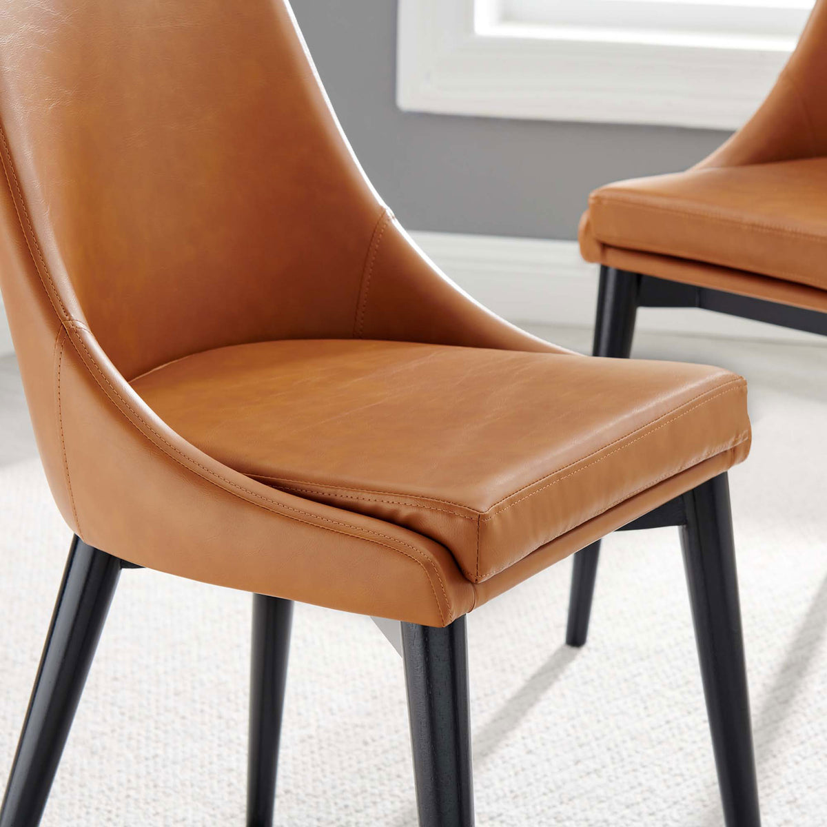 Tan vegan leather dining chair seat styled in a bright dining space with soft flooring || EEI-2226-TAN || detail_room