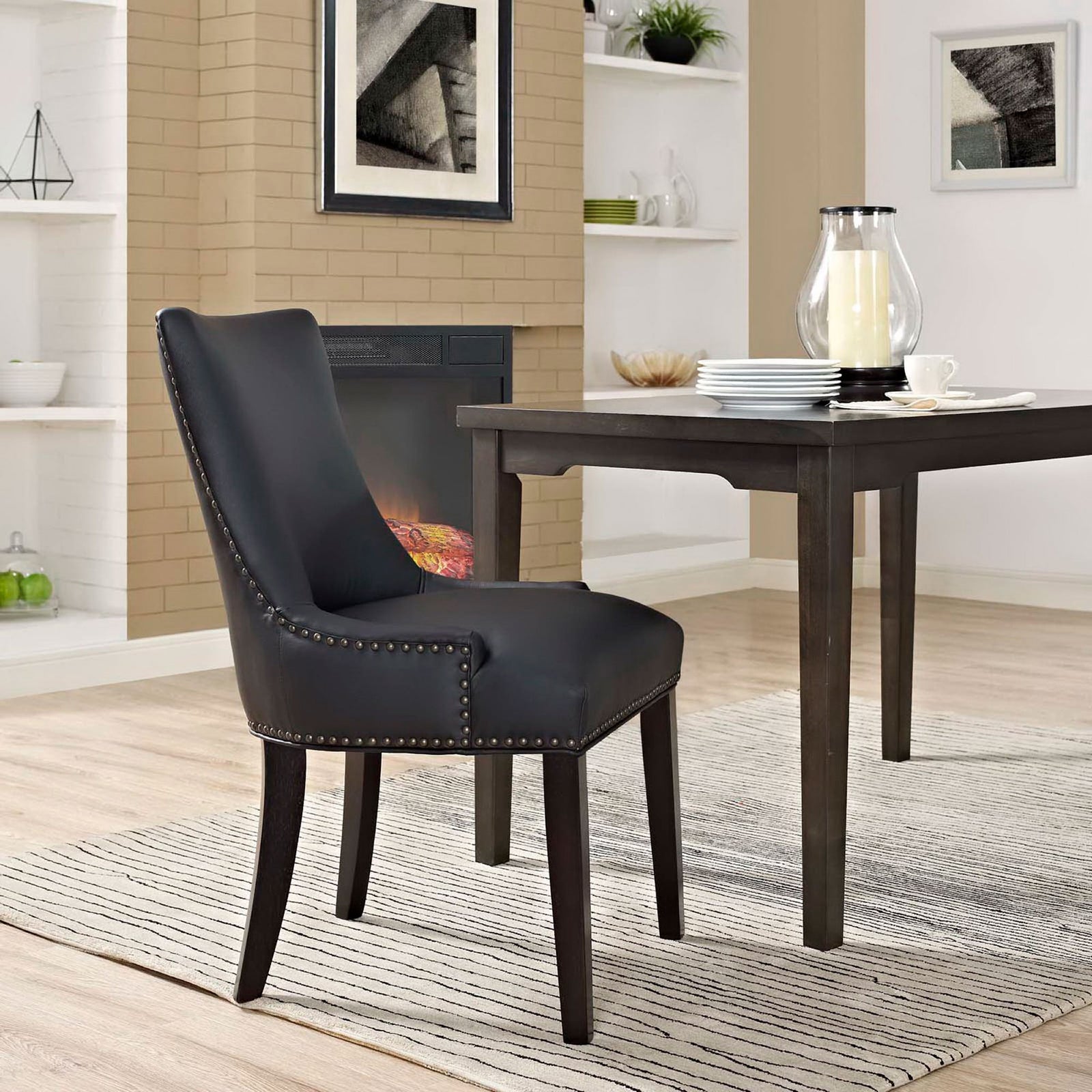 Black vegan leather dining chair styled at a wood table, adding modern elegance to a bright dining room || EEI-2228-BLK || front_angle_room
