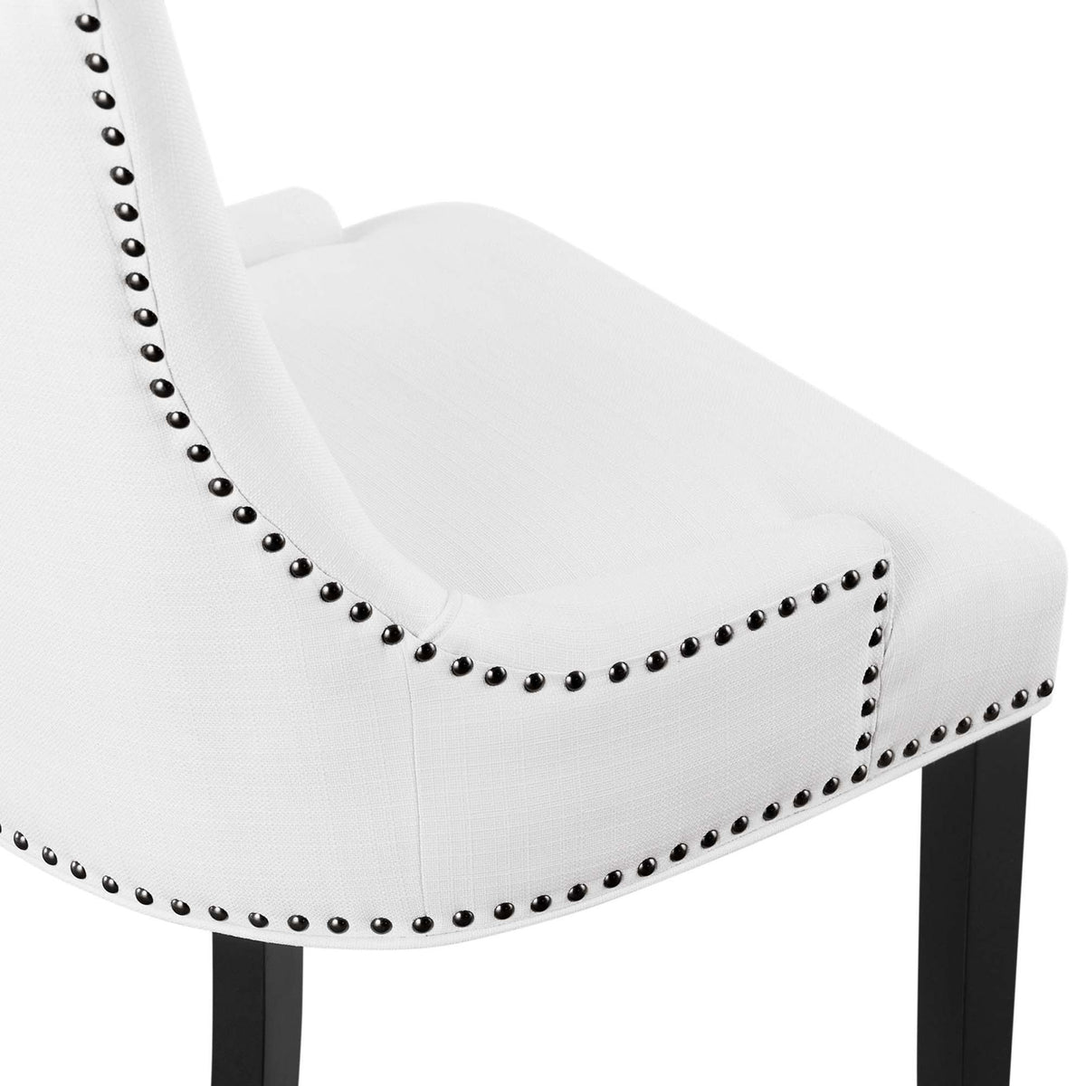 White fabric upholstery with neatly aligned nailhead trim along the seat and back of the dining chair || EEI-2229-WHI || detail_studio