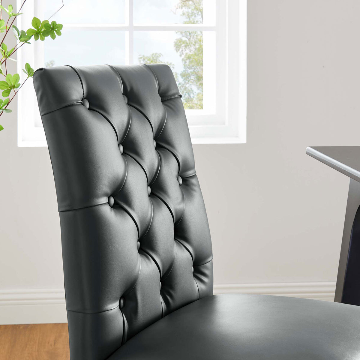 Duchess gray tufted dining chair beside a bright window for an inviting modern dining space || EEI-2230-GRY || detail_room