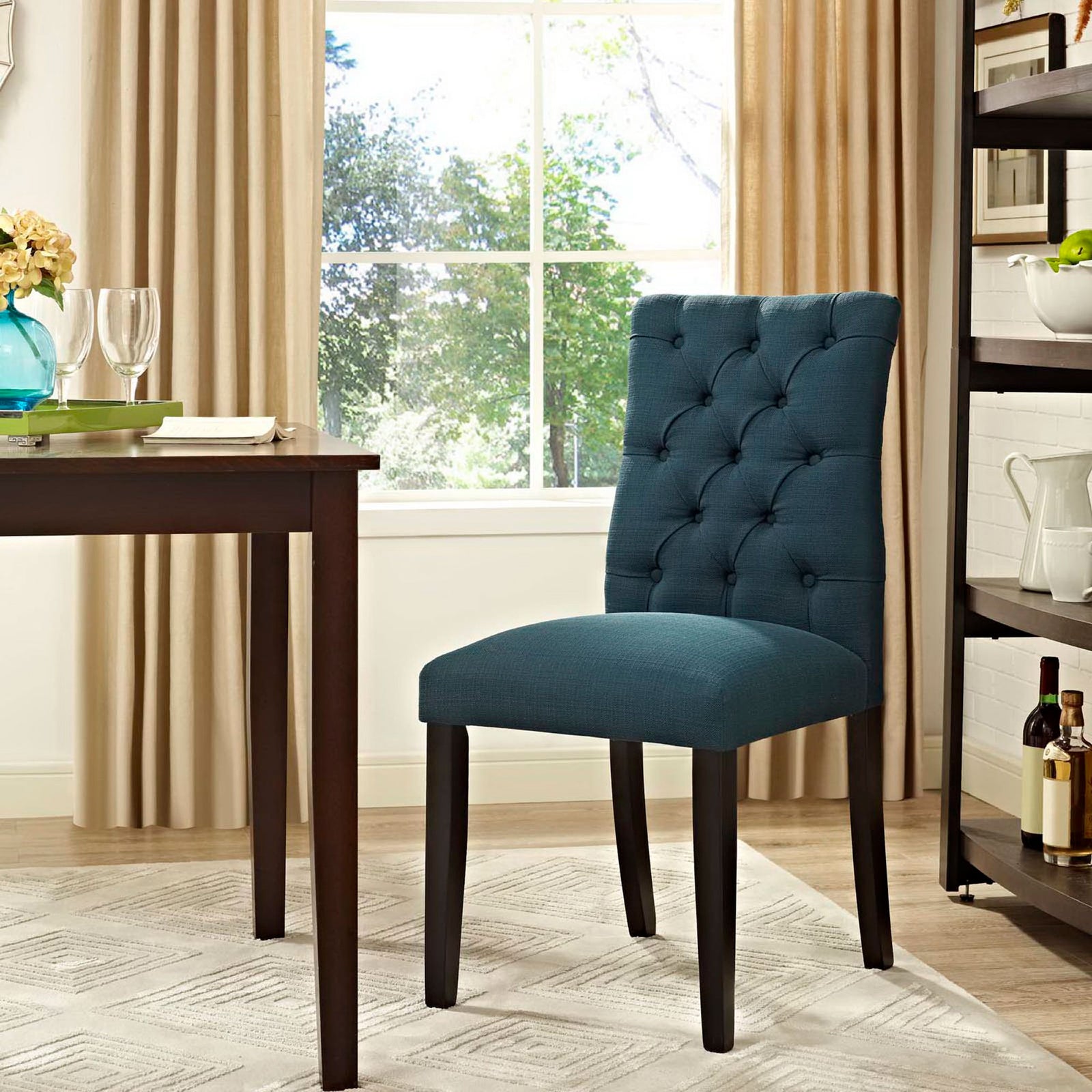 Azure tufted dining chair bringing a rich pop of color to a bright, contemporary dining room setting. || EEI-2231-AZU || front_angle_room