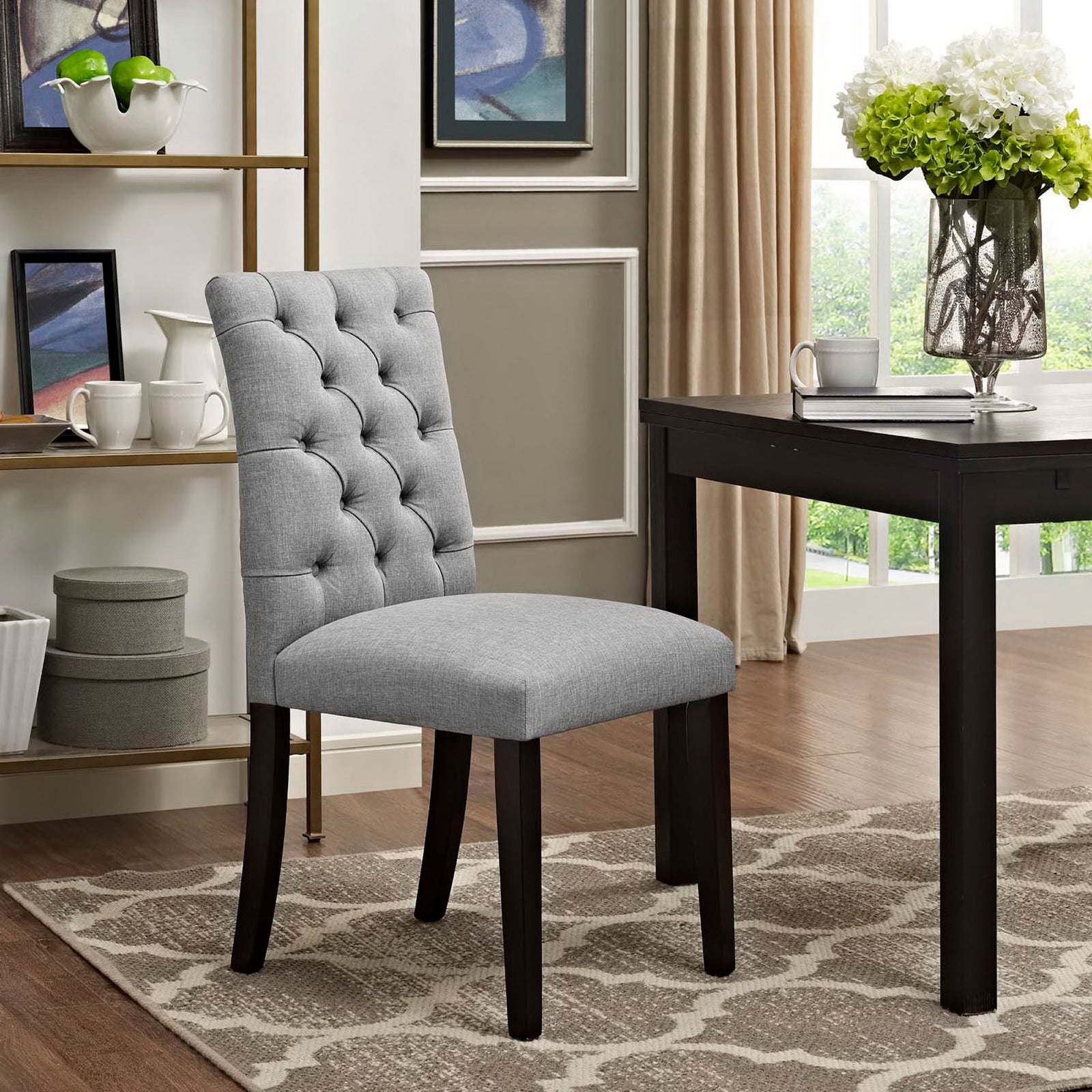 Light gray tufted dining chair styled in a modern dining room with dark wood table and neutral decor || EEI-2231-LGR || front_angle_room