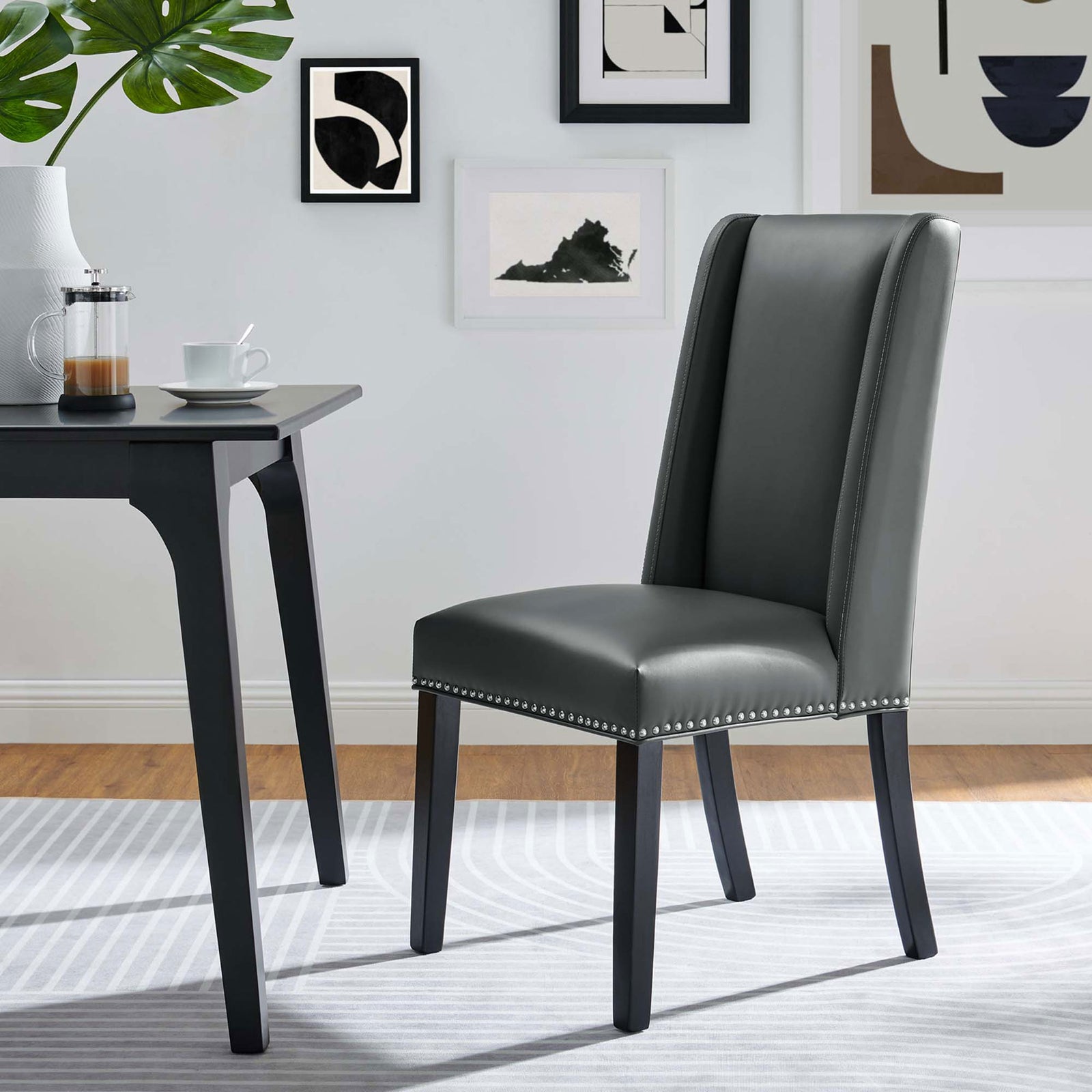 Gray vegan leather dining chair styled as a chic desk chair in a contemporary home office || EEI-2232-GRY || front_angle_room