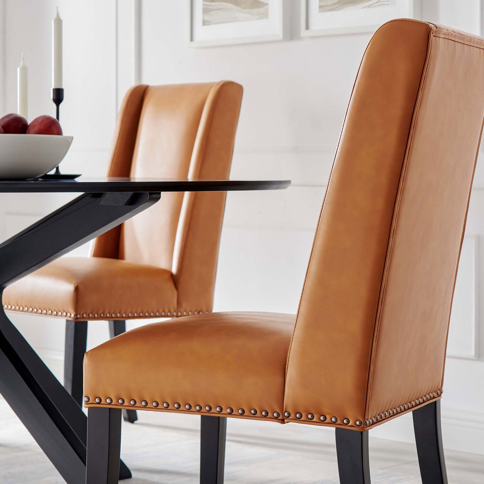 Pair of tan vegan leather dining chairs brings tailored comfort to a contemporary dining table. || EEI-2232-TAN || detail_room