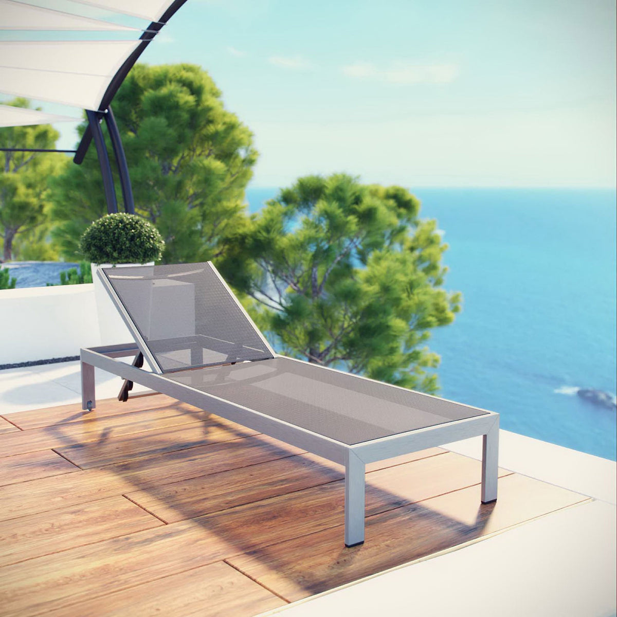 Gray mesh Shore chaise on a coastal deck for relaxing by the water || EEI-2249-SLV-GRY || front_angle_room