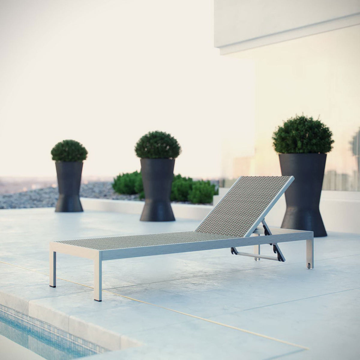 Woven rattan Shore chaise on a modern rooftop pool deck for relaxed lounging || EEI-2250-SLV-GRY || front_angle_room