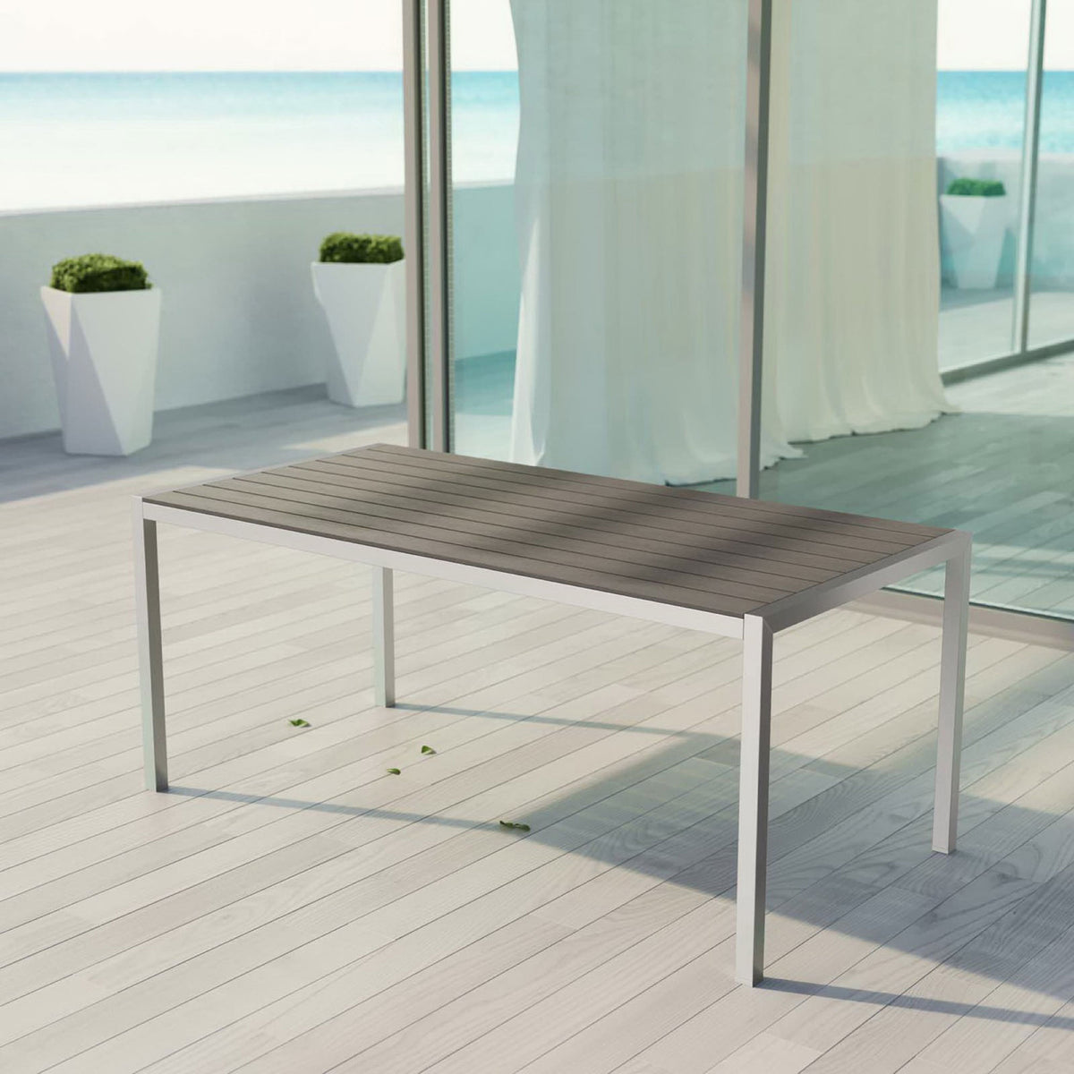 Shore collection patio dining table styled on a coastal deck with sleek silver frame and gray top || EEI-2251-SLV-GRY || front_angle_room
