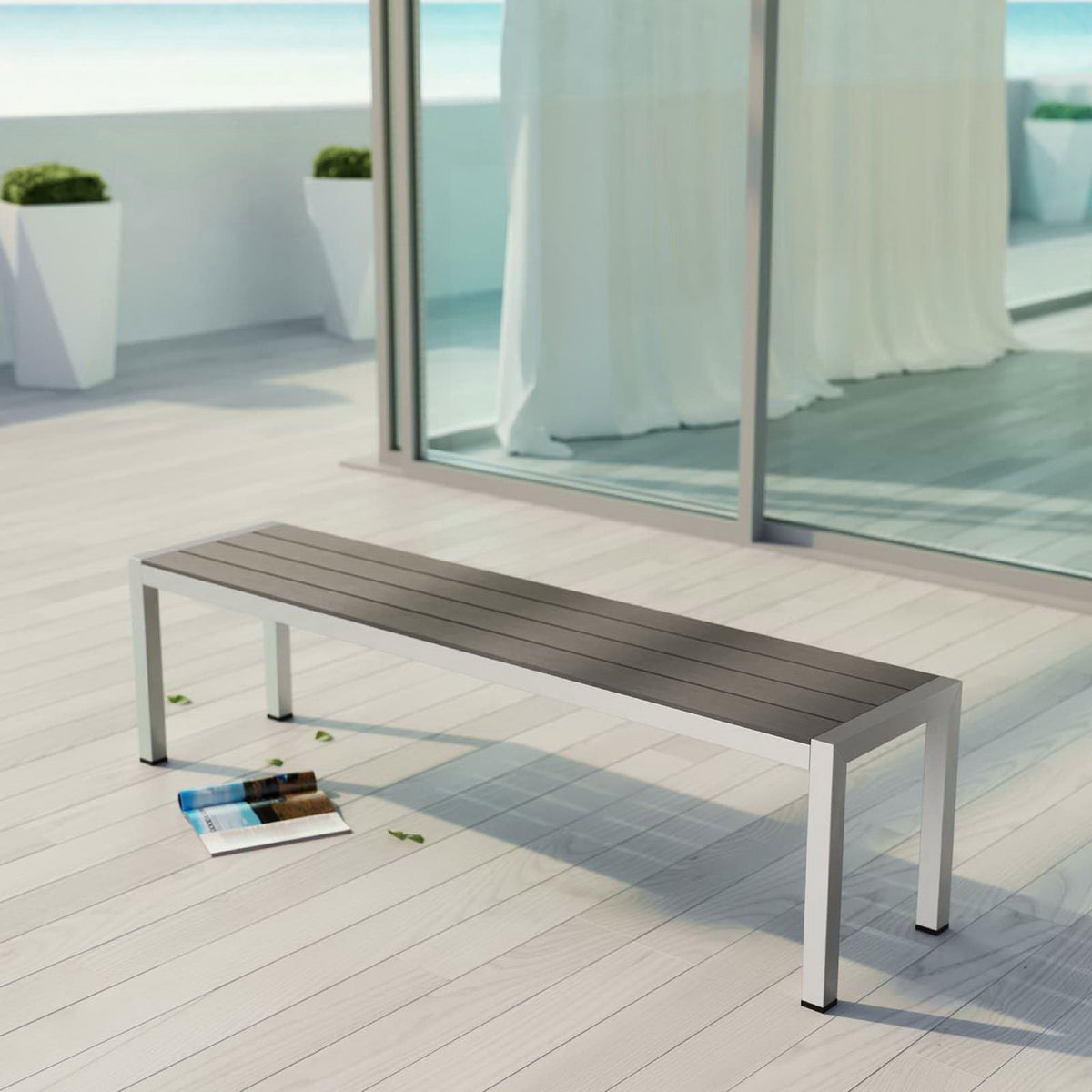 Shore collection outdoor bench styled on a modern seaside patio with sleek gray slatted top || EEI-2252-SLV-GRY || front_angle_room