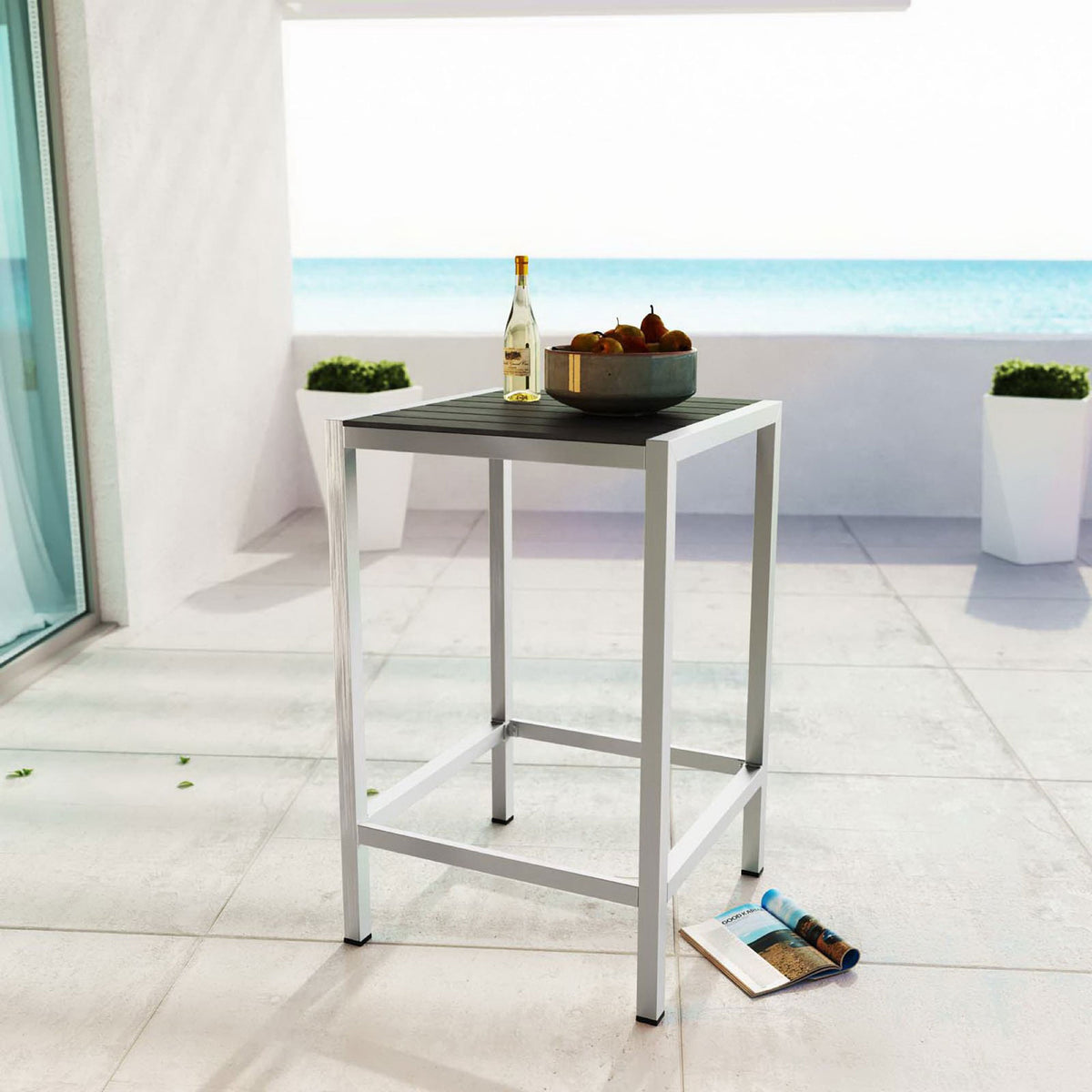Square silver gray bar table styled on a bright balcony for relaxed outdoor entertaining. || EEI-2256-SLV-GRY || front_angle_room