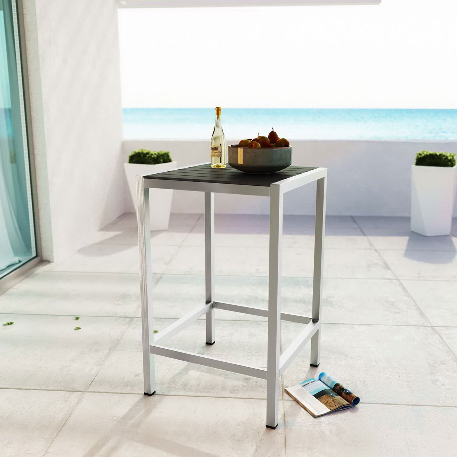 Square silver gray bar table styled on a bright balcony for relaxed outdoor entertaining. || EEI-2256-SLV-GRY || front_angle_room