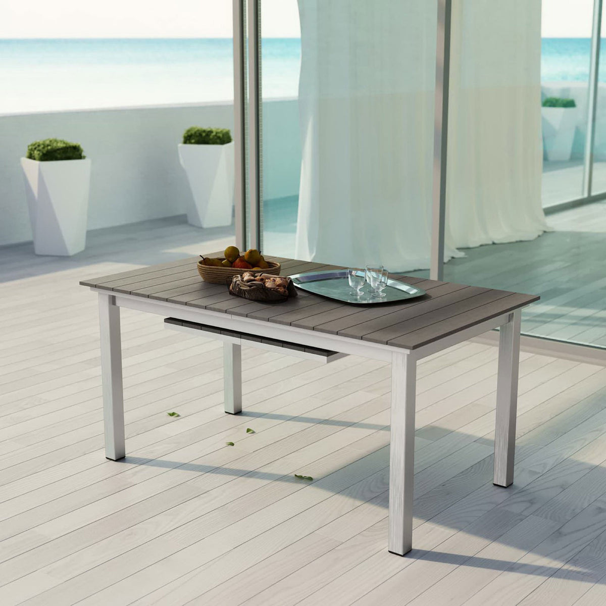 Shore patio extension table in compact setup on a modern deck with coastal ocean backdrop || EEI-2257-SLV-GRY || front_angle_room