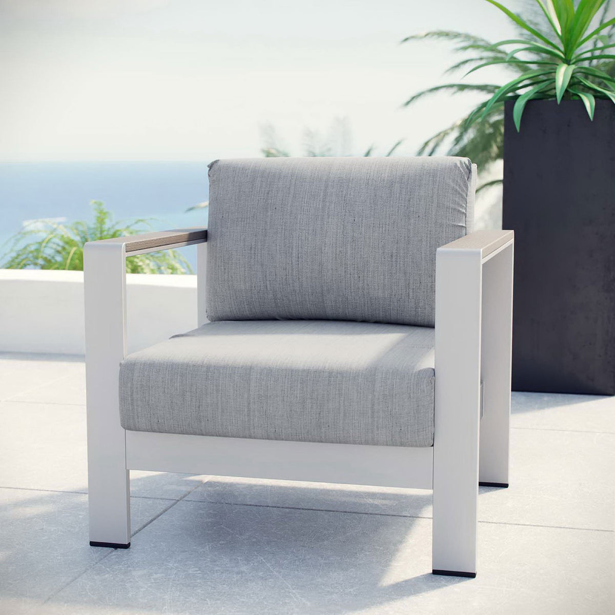 Silver gray outdoor armchair styled on a sunny patio for relaxed coastal lounging || EEI-2266-SLV-GRY || front_angle_room