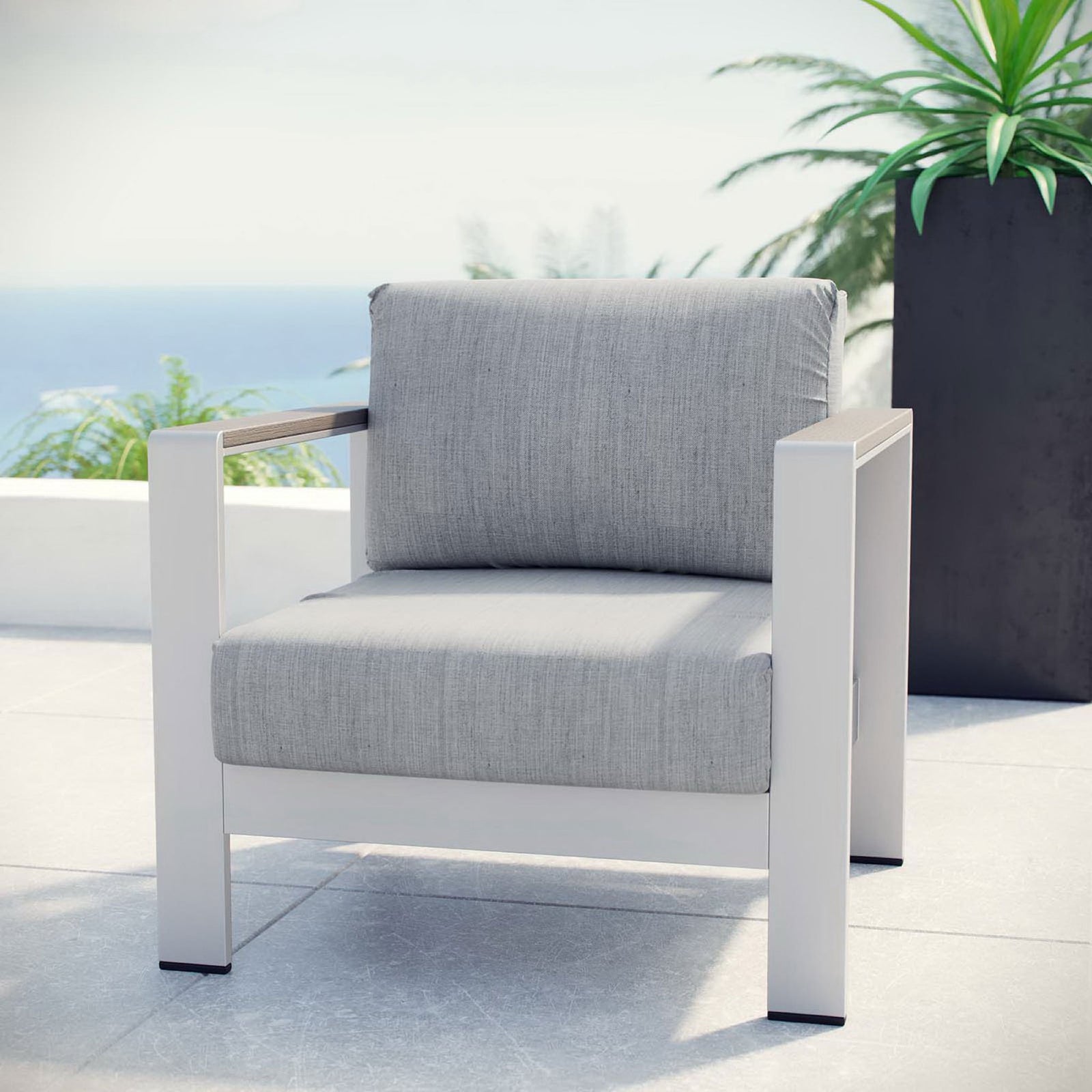 Silver gray outdoor armchair styled on a sunny patio for relaxed coastal lounging || EEI-2266-SLV-GRY || front_angle_room