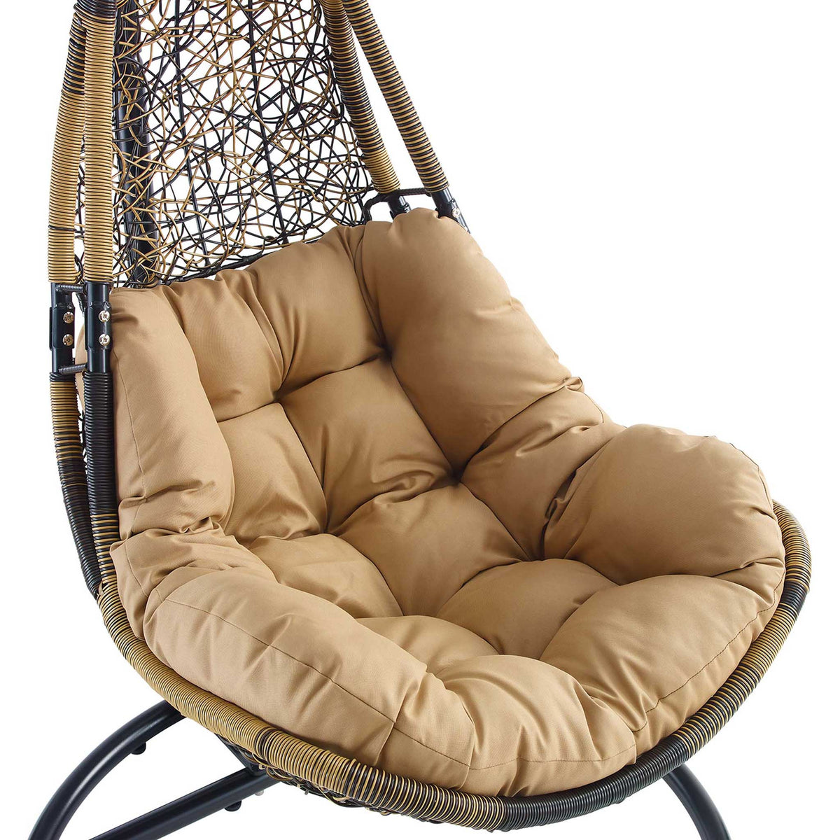 Button tufted mocha cushion nestled into the rounded brown wicker swing chair seat.