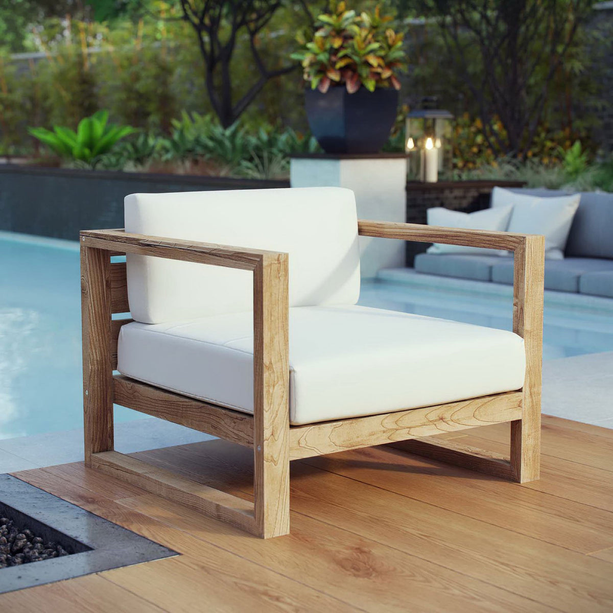 Upland teak armchair adds resort-style comfort with crisp white cushions beside a modern poolside deck || EEI-2706-NAT-WHI || front_angle_room
