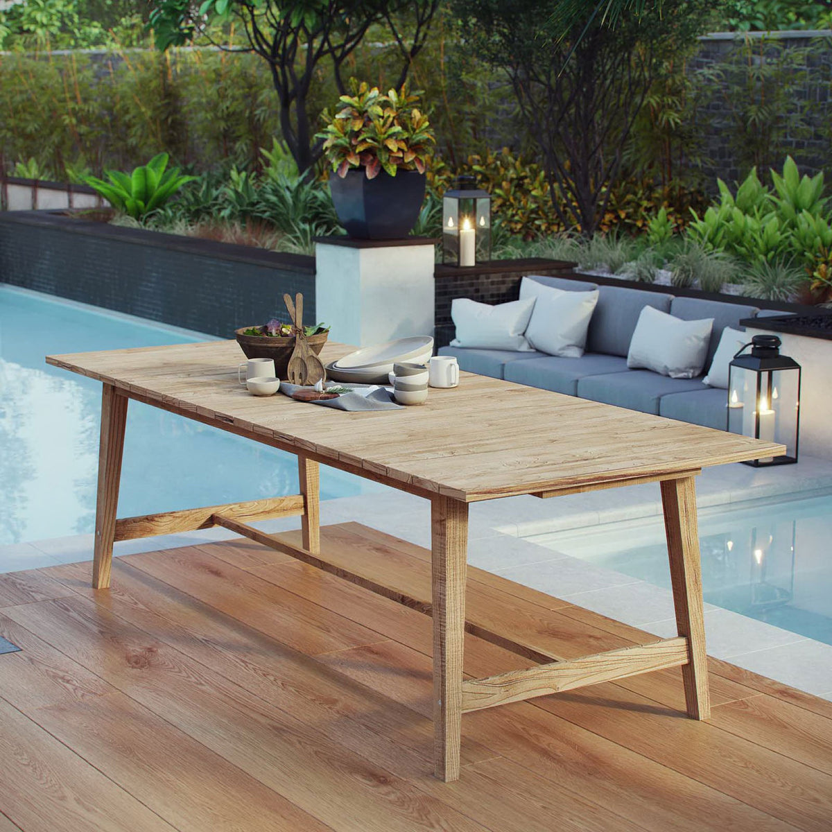 Teak outdoor dining table styled on a poolside deck with tableware and decor || EEI-2713-NAT || front_angle_room