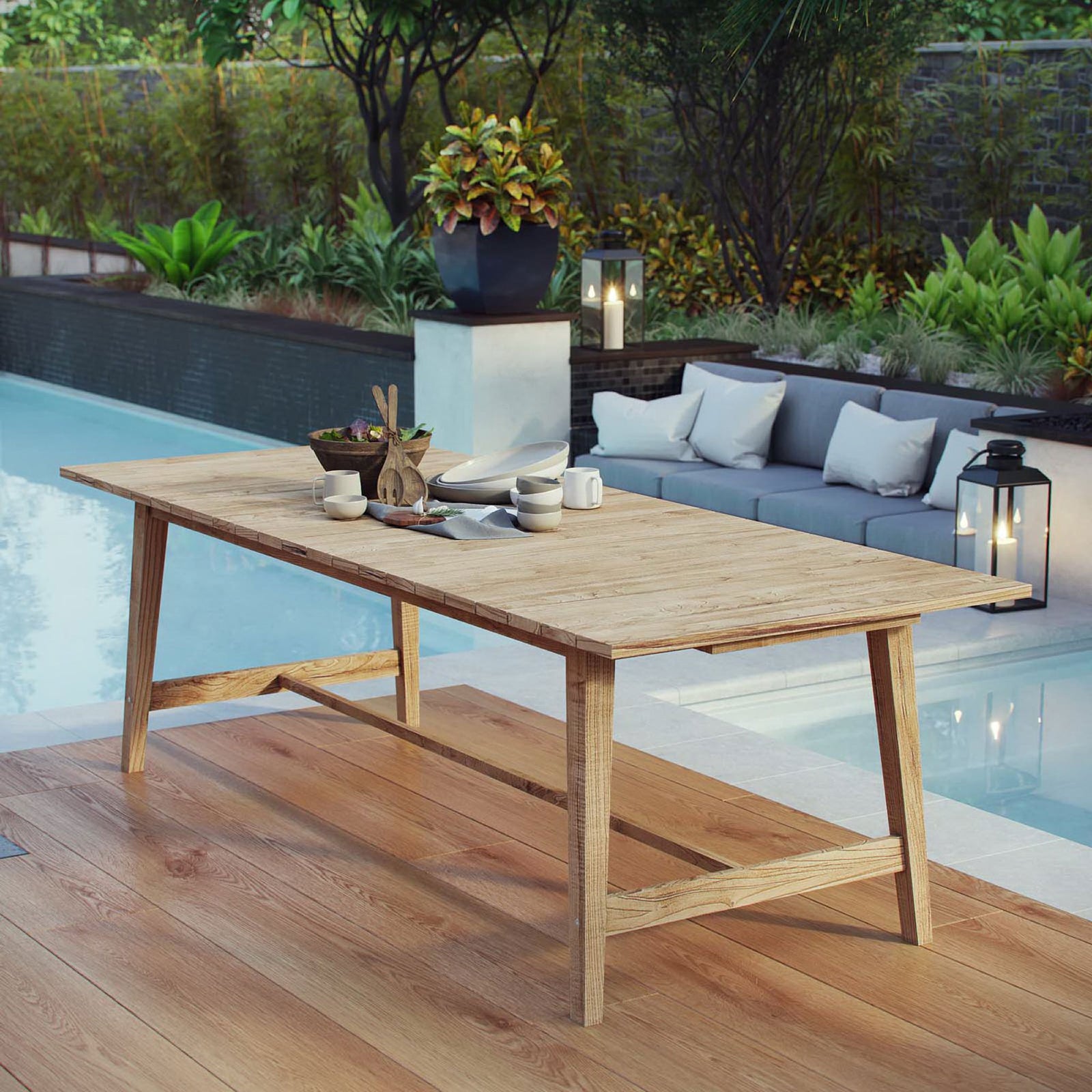 Teak outdoor dining table styled on a poolside deck with tableware and decor || EEI-2713-NAT || front_angle_room