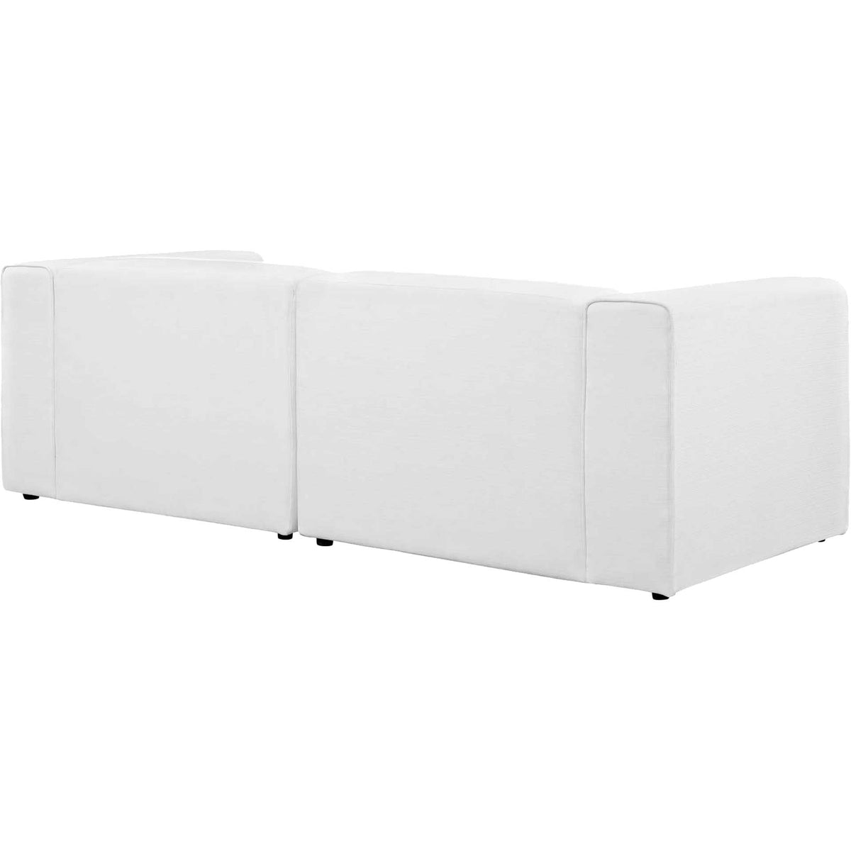 Tailored white upholstery wraps the sofa's streamlined back and broad arms