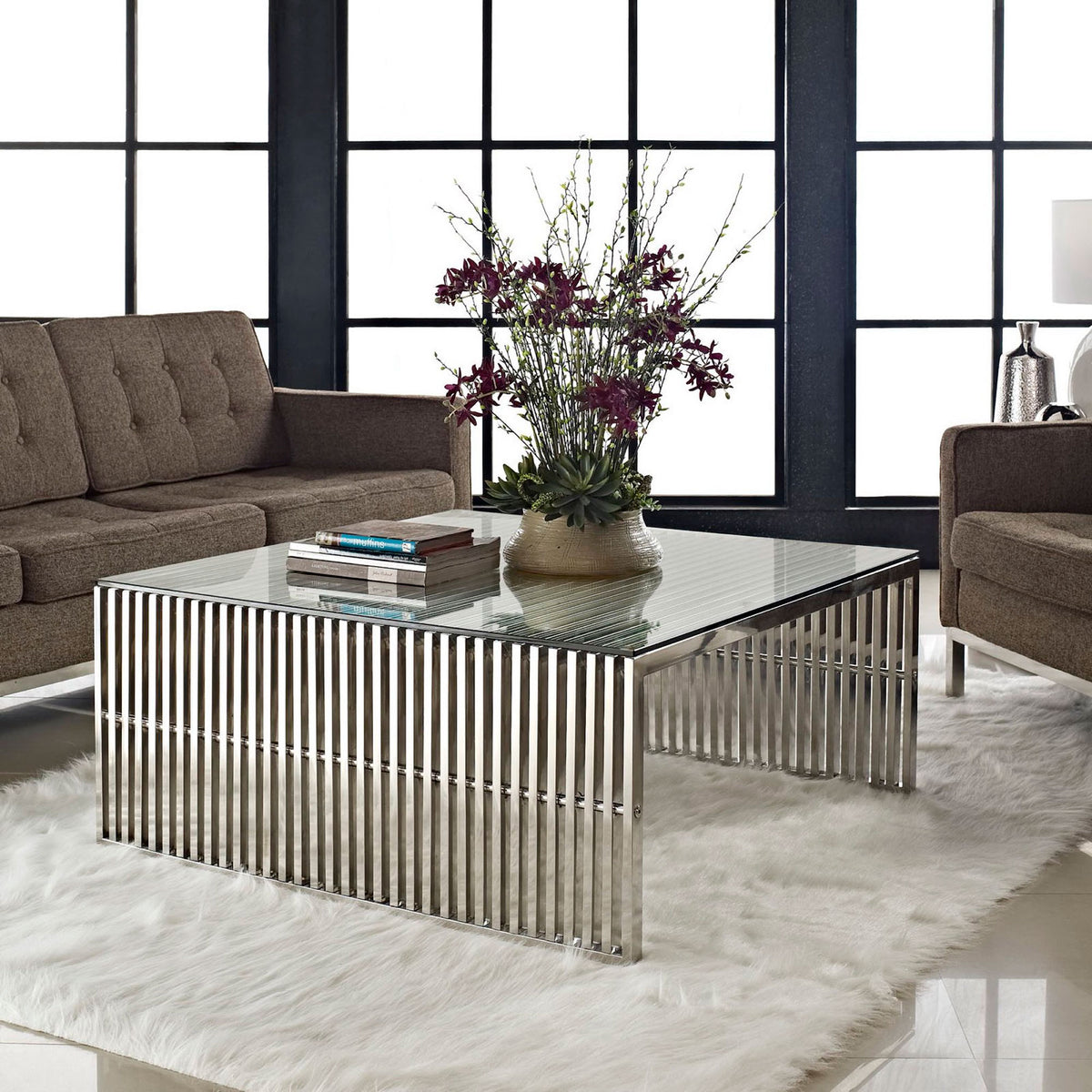 Modern coffee table elevates your living room with glass top clarity and reflective steel lines. || EEI-284-SLV || front_angle_room