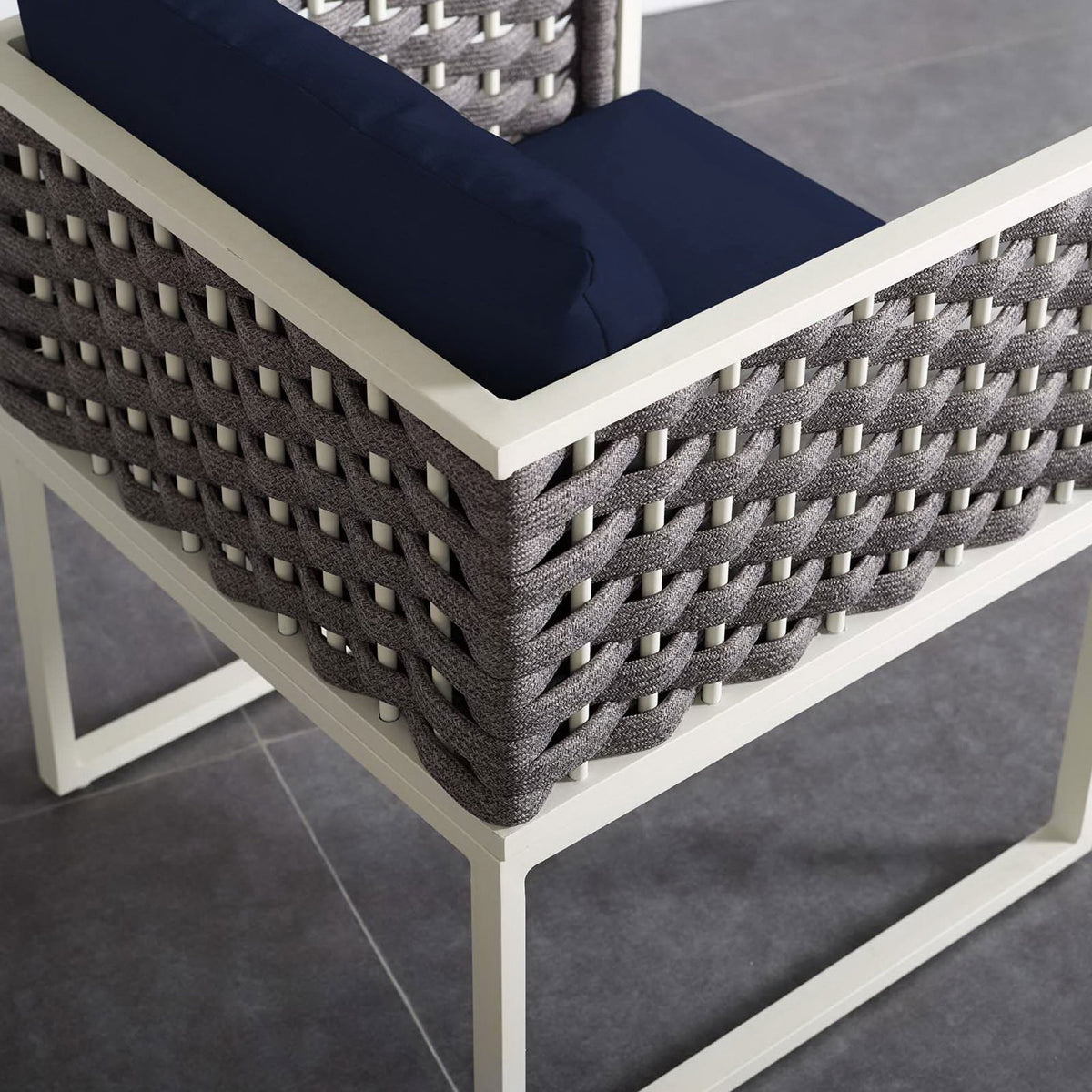 Navy cushioned patio armchair corner showing textured rope sides and open square base on tile floor || EEI-3053-WHI-NAV || detail_room